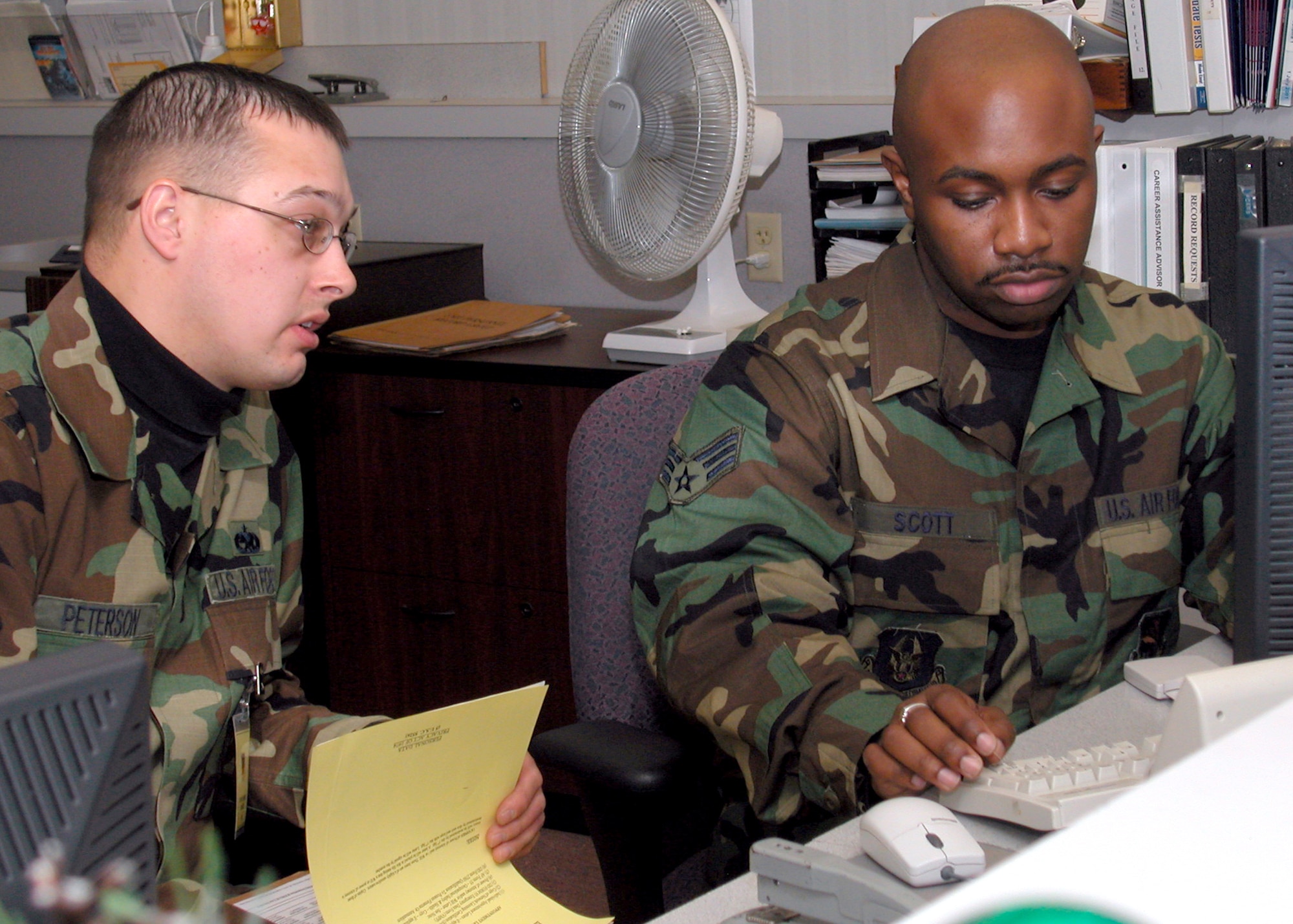 GRISSOM AIR RESERVE BASE, Ind., -- Tech. Sgt. Jason Peterson, left,  a new arrival to the 434th Maintenance Squadron, is inprocessed by Senior Airman James Scott, a personnel technician with the 434th Military Personnel Flight during a recent unit training assembly. Special programs are in place to help newcomers to the wing.  (U.S. Air Force photo/Senior Airman Chris Bolen)