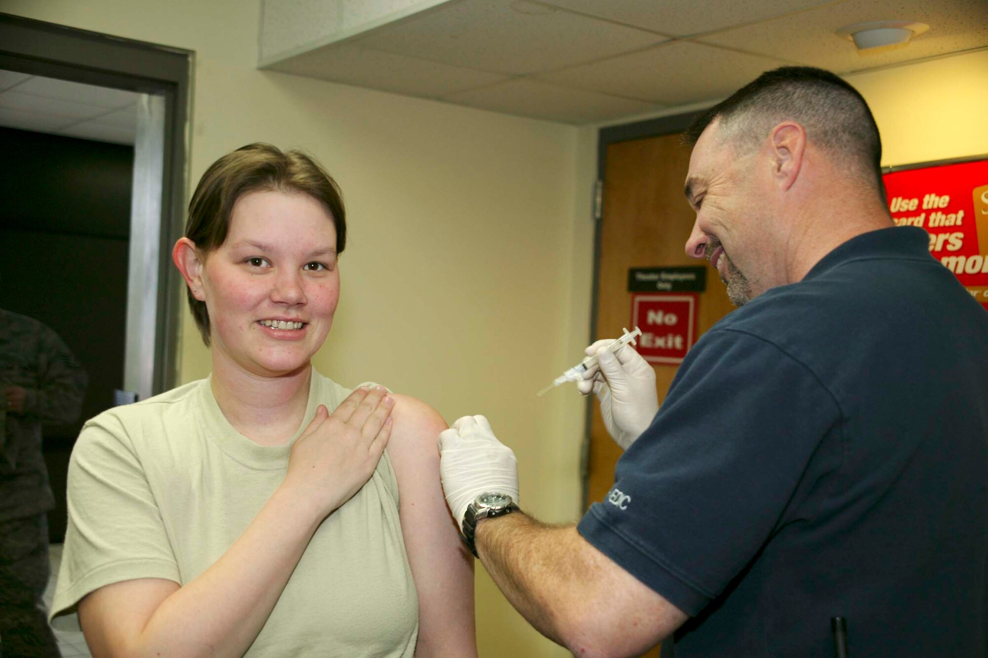 SHAW AIR FORCE BASE, S.C.-- Robert Weaver, 20th Medical Operations Squadron paramedic, administers an influenza vaccine to Senior Airman Leah Thomas, 20th Operational Support Squadron aircrew flight equipment specialist, Dec. 4 at the base theater. The flu vaccine reduces the chance of catching the flu by up to 80 percent during season. (U.S. Air Force photo/Senior Airman Holly Brown)