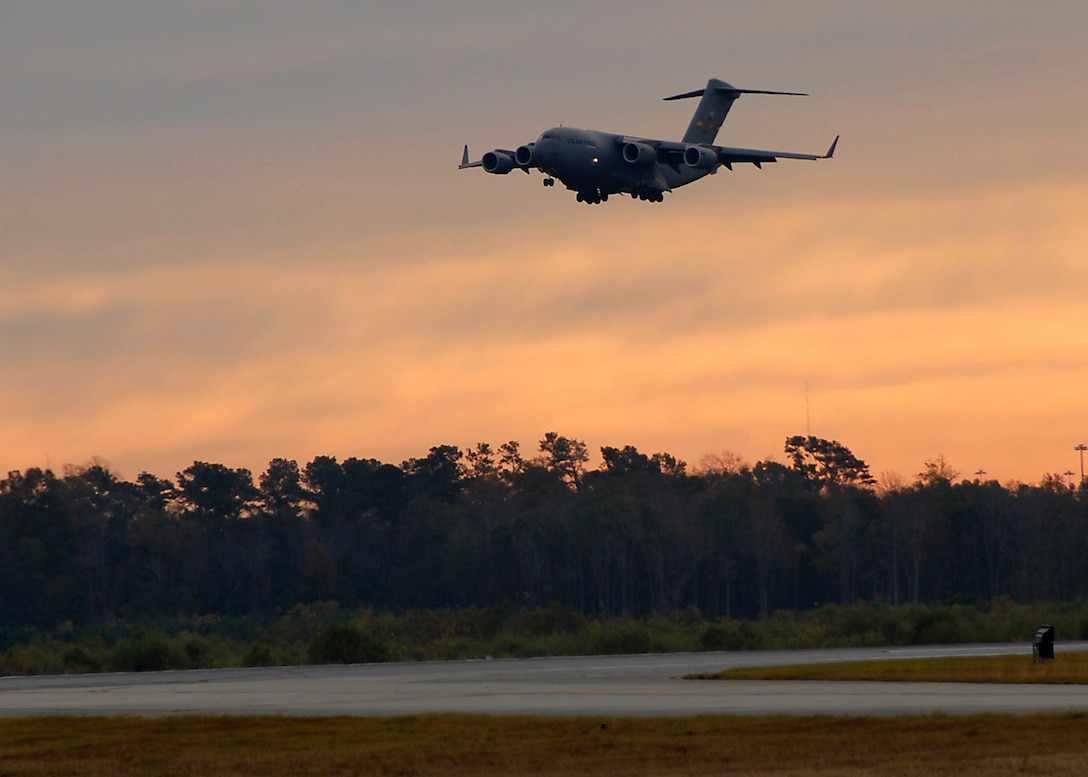The 315th Airlift Wing aircrew that broke the 100,000 flight hour mark in support of the Global War on Terror lands their C-17 in the early morning hours at Charleston Air Force Base, S.C. (photo by Capt. Chett Collier)