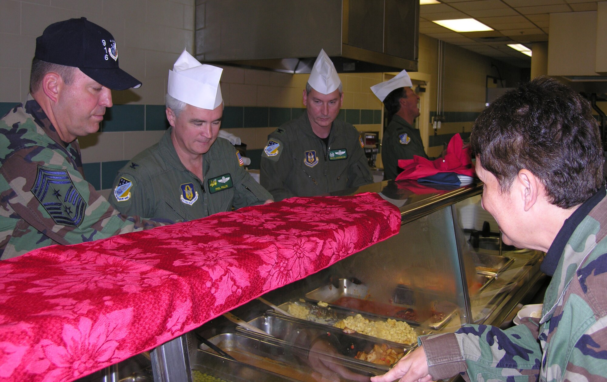 SEYMOUR JOHNSON AIR FORCE BASE, N.C.-- Command Chief Master Sgt. Lester Boltinhouse, and Colonels Phil Fallin, Fritz Linsenmeyer and Tony Taylor of the 916th Air Refueling Wing here, serve chow during the Unit Training Assembly on December 2. The colonels and chief got into the spirit and served up holiday cheer to the members of the Air Force Reserve tanker wing.