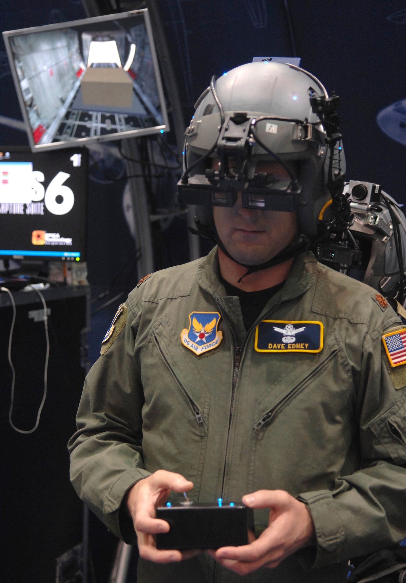 Maj. Dave Edney tries on the enhanced loadmaster training module that uses augmented reality Nov. 30 during the Interservice/Industry Training, Simulation and Education Conference in Orlando, Fla. The augmented reality allows trainees to see real and virtual reality as the visual display adds different scenarios to training. (U.S. Air Force photo/Tech. Sgt. Larry A. Simmons) 
