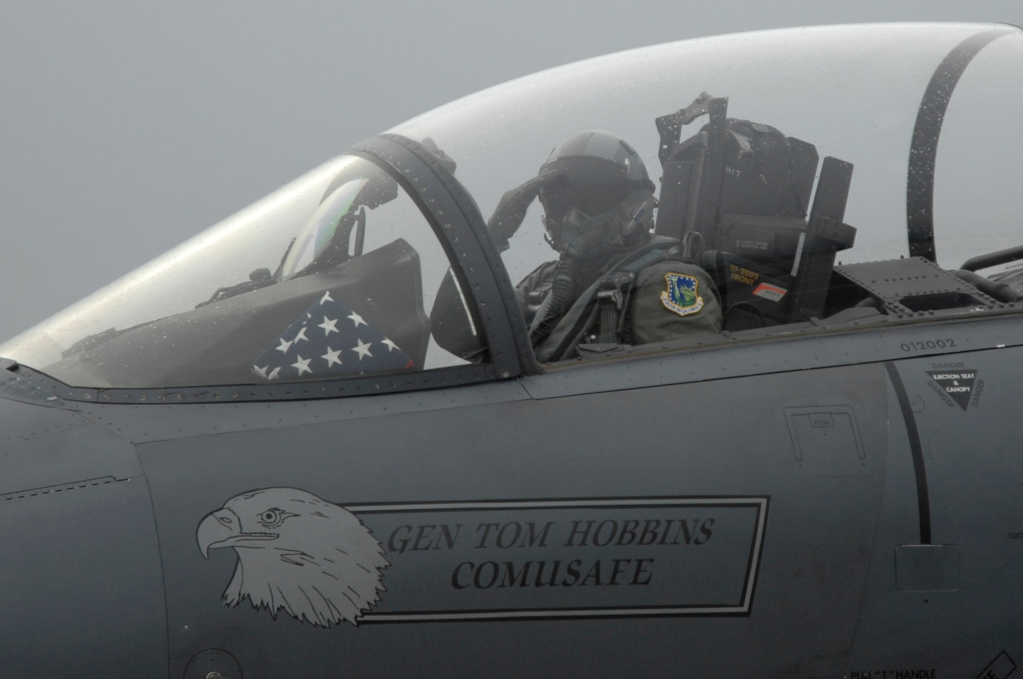 Gen. William T. Hobbins, U.S. Air Forces in Europe commander, salutes Liberty Warriors as he passes by during his final flight in an F-15E Strike Eagle at RAF Lakenheath, England Dec. 4. General Hobbins is retiring after 39 years of service. (U.S. Air Force photo by Airman Perry Aston) 