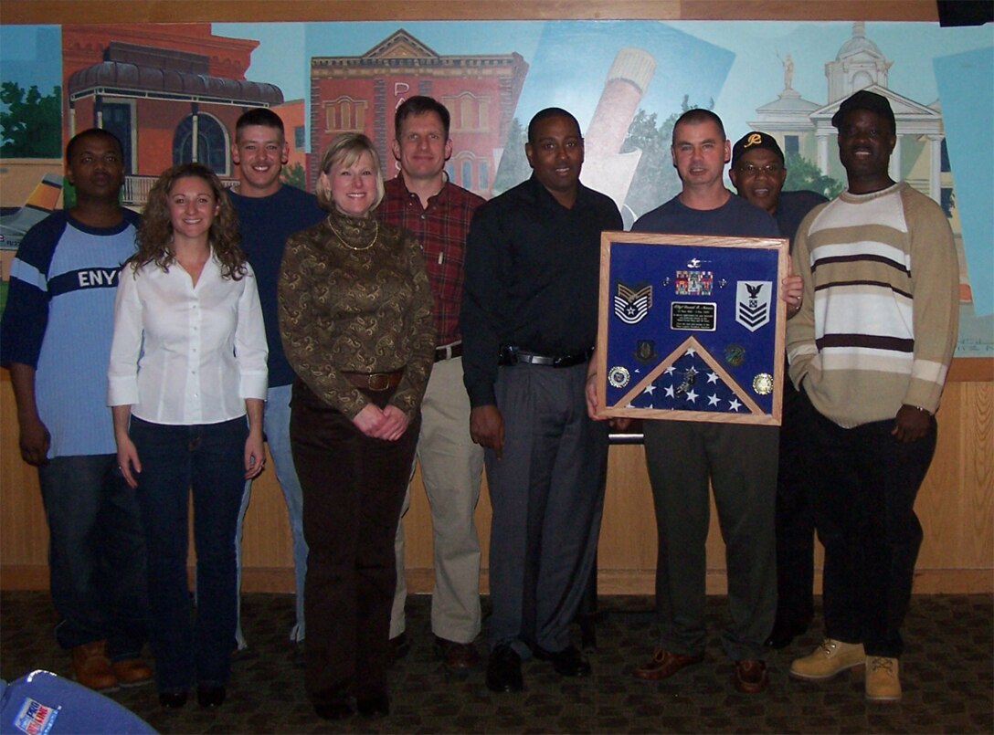 SEYMOUR JOHNSON AIR FORCE BASE, N.C. -- Tech. Sgt. David Nance (holding shadow box) retires from the 916th Air Refueling Wing Logistics Readiness Squadron during the December unit training weekend. Sgt. Nance served the wing for as a transportation specialist.