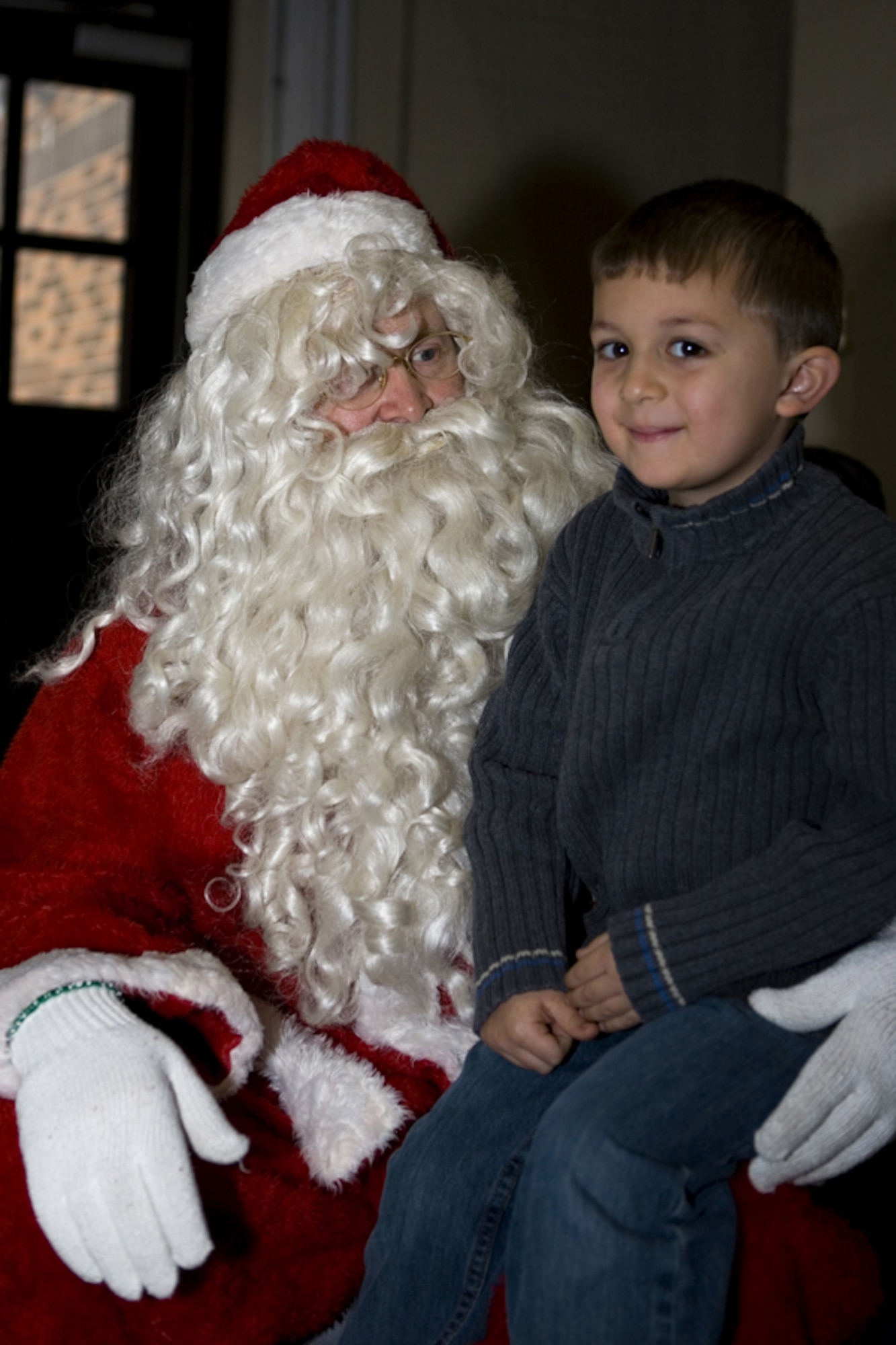 GRISSOM AIR RESERVE BASE, Ind. -- Five-year-old Abram Shepherd lets Santa Claus know what he wants for Christmas during Santa's recent visit to Grissom ARB.  Santa made a surprise visit to the base as he prepares for the Christmas season. Santa's visit was made possible by the joint efforts of the Airmen Family Readiness Center and the Grissom Fire Department. (U.S. Air Force photo/Senior Airman Omar Delacruz)
