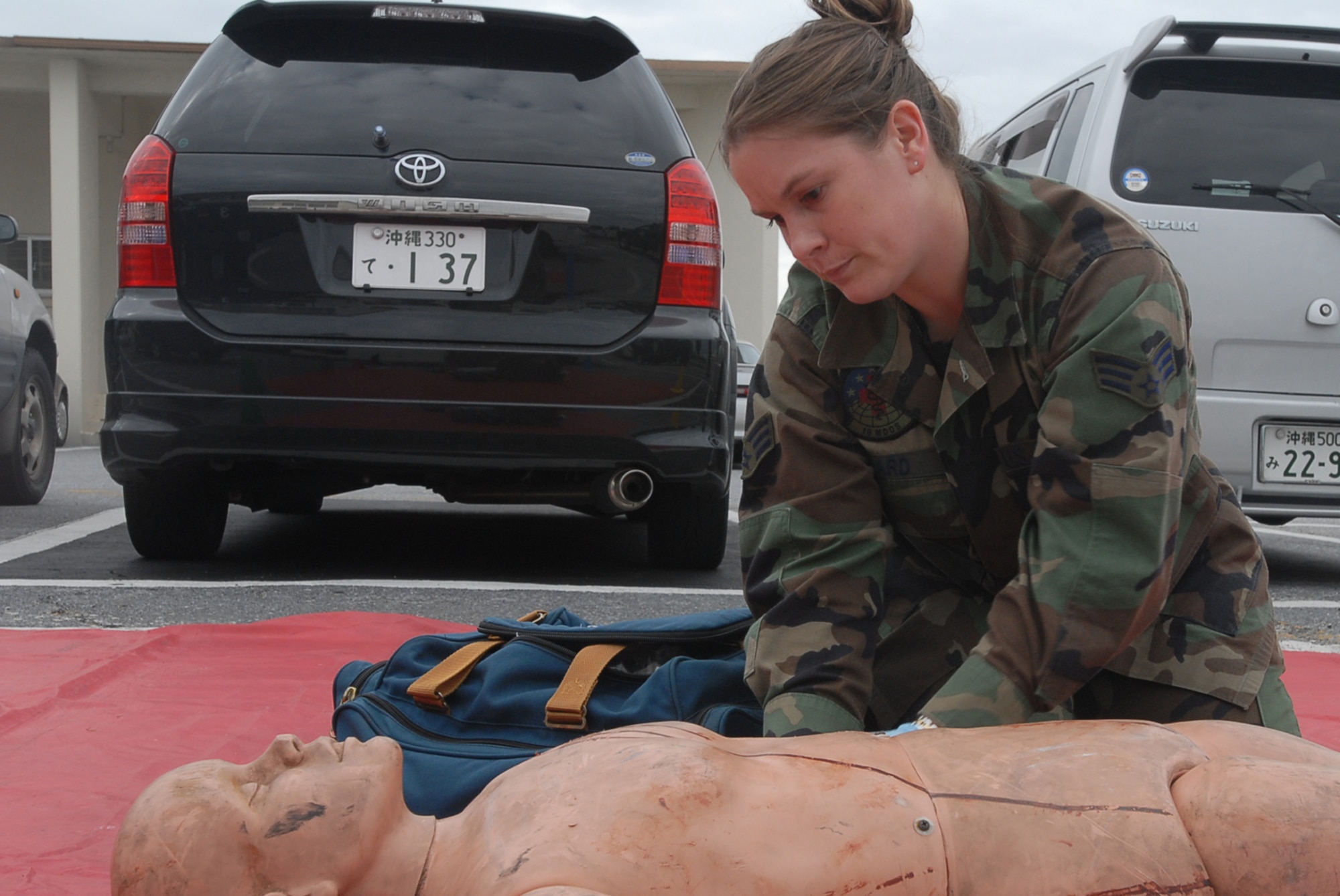 Senior Airman Ashley Sard, 18th Medical Operations Squadron, checks the status of a casaulty during a Local Operational Readiness Exercise Beverly High 08-02 scenario at Kadena Air Base, Japan, Dec. 4, 2007. This scenario tested the paramedics ability to treat people injured in a fire. (U.S. Air Force /Senior Airman Darnell T. Cannady) 