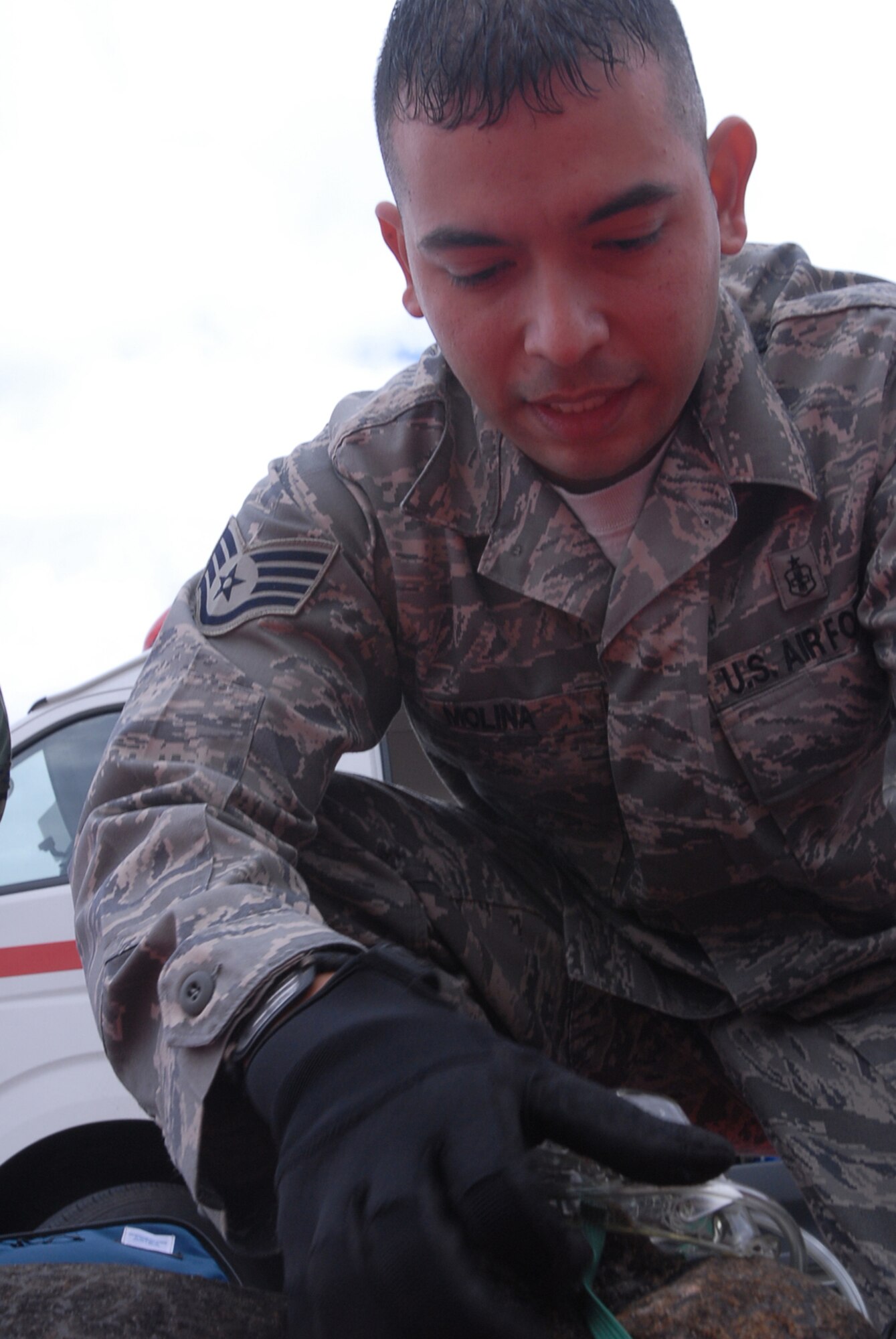Staff Sgt. Manuel Molina, 18th Medical Operations Squadron, places an oxygen mask over a burned casualty during a Local Operational Readiness Exercise Beverly High 08-02 scenario at Kadena Air Base, Japan, Dec. 4, 2007. This scenario tested the paramedic ability to respond to  personnel injured during a fire. (U.S. Air Force /Senior Airman Darnell T. Cannady) 