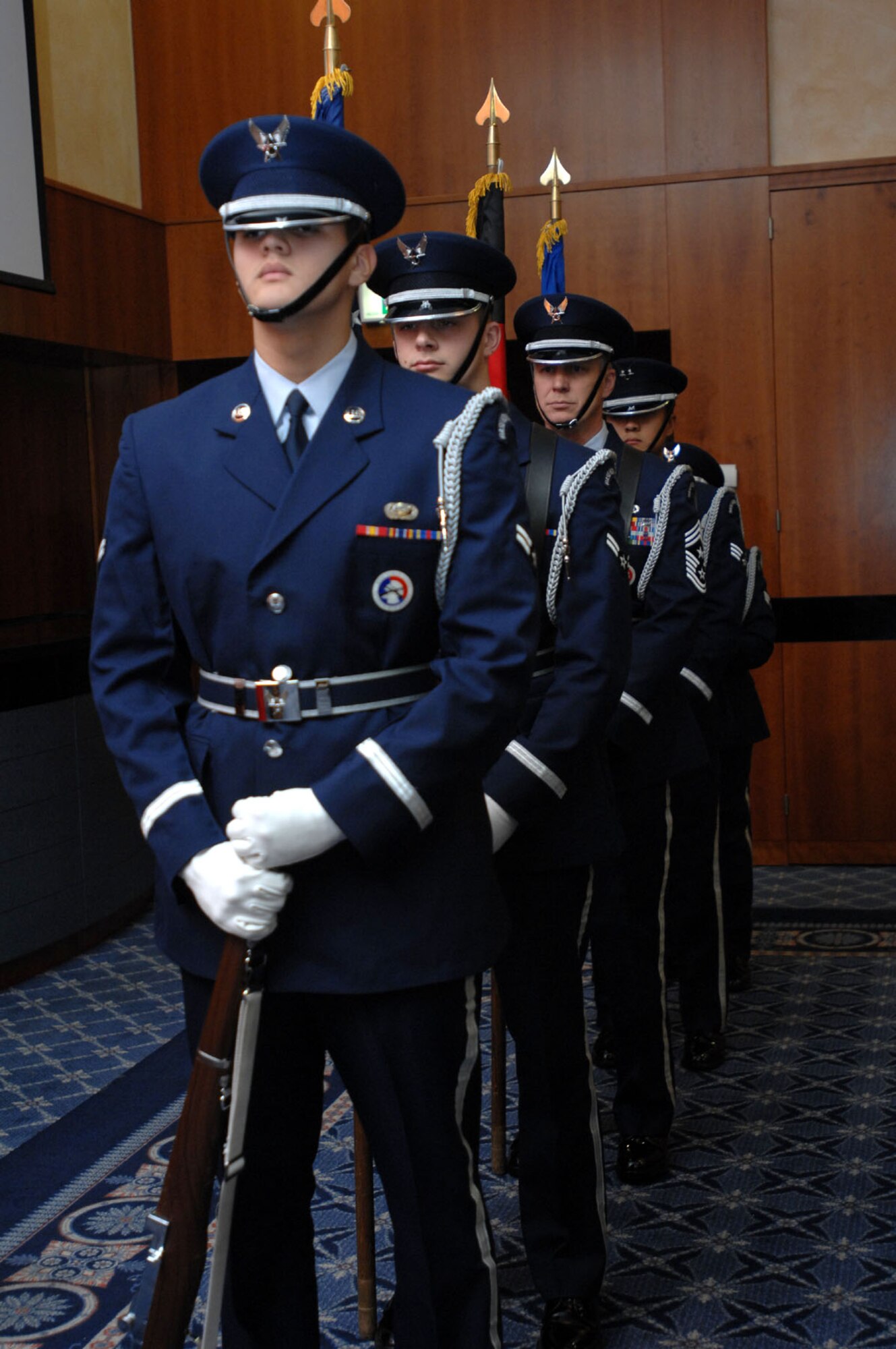 SPANGDAHLEM AIR BASE, Germany -- Chief Master Sgt. Vance Clarke, 52nd Fighter Wing command chief, along with members of the 52nd FW Base Honor Guard stand ready to present the colors at the base promotion ceremony at Club Eifel Dec. 3, 2007. (U.S. Air Force photo/Airman 1st Class Jenifer Calhoun)