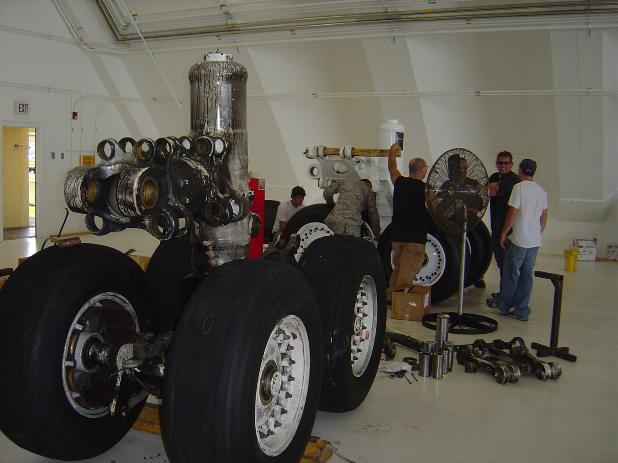 Maintenance crew from Tinker AFB, Okla., replace the main landing gear on the B-1B Lancer that caught fire on Andersen September 2005. The aircraft is scheduled to return to full mission capability status in summer of 2008. (Courtesy photo)