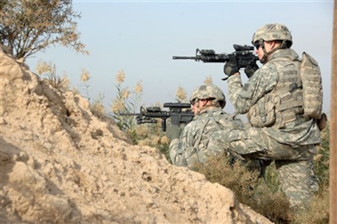 U.S. Army soldiers survey the area after a firefight during a dismounted patrol in Arab Jabour, Iraq, on Nov. 29, 2007.  Soldiers from 2nd Platoon, Bravo Company, 1st Battalion, 30th Infantry Regiment, 2nd Brigade Combat Team, 3rd Infantry Division were to maintain and keep the local area secure when they received small arms fire.  