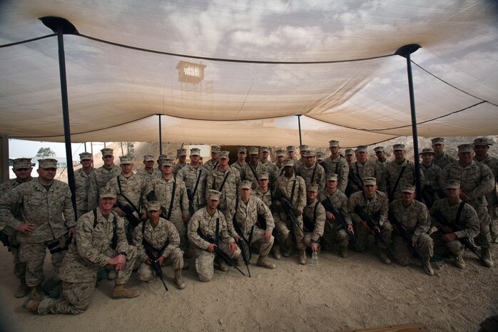 AL TAQADDUM, Iraq (Dec. 5, 2007) ? The Marines of Battery F, 2nd Battalion, 14th Marine Regiment take time for a photograph opportunity. These reservists out of Oklahoma are the first Marine Corps unit to utilize the new HIMARS weapon system in Iraq.