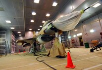 KUNSAN AIR BASE, South Korea --  Senior Airman Matthew Wuensch, 8th Maintenance Squadron fabrication flight, checks the stencil alignment for the finishing touches on an F-16 Fighting Falcon here. The aircraft is the first to have an arctic scheme. (U.S. Air Force photo/Chief Master Sgt. William McElligot)