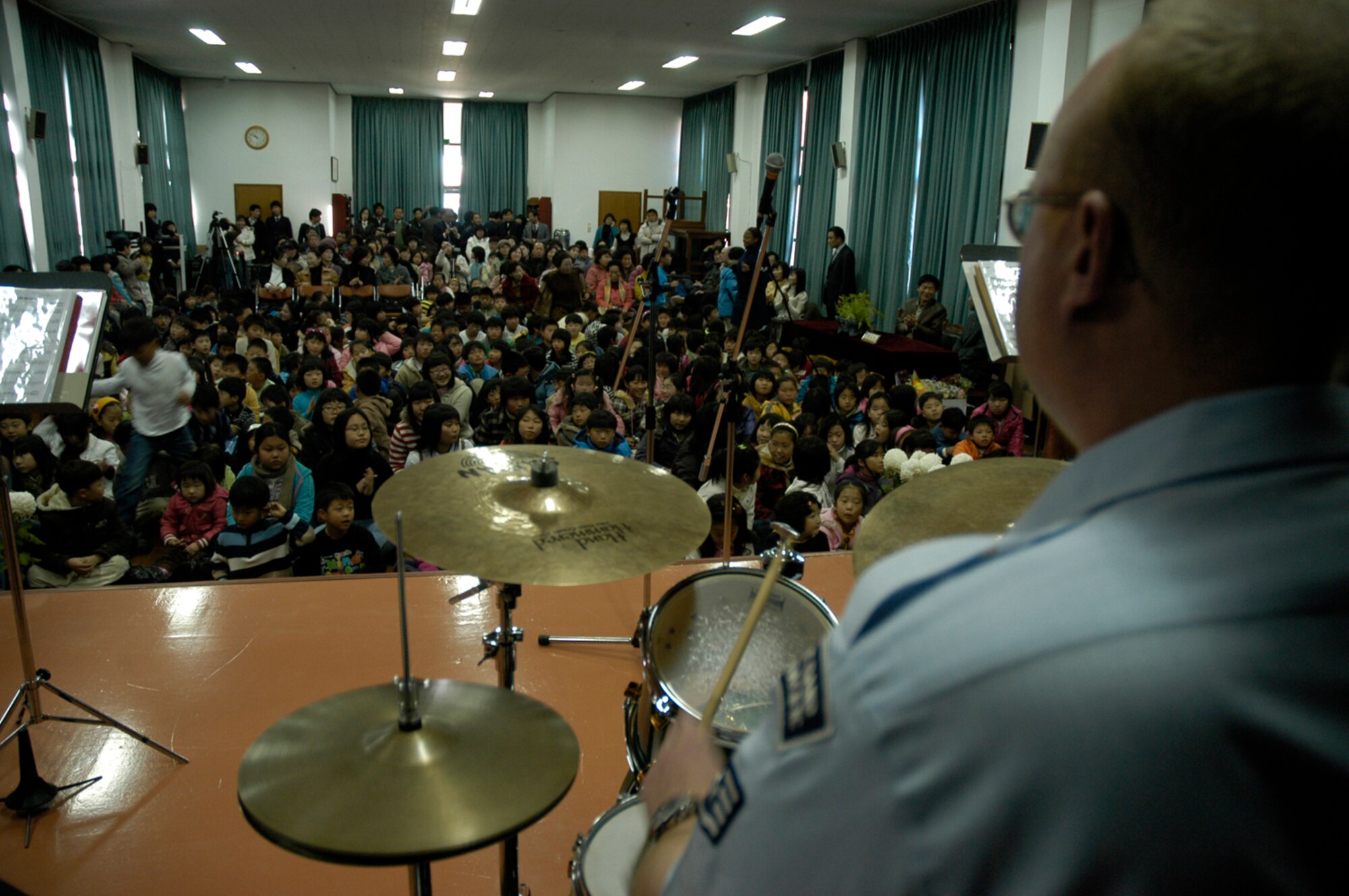 KUNSAN AIR BASE, South Korea -- Air Force Band of the Pacific drummer Staff Sgt. Darren Raybourne performs for students at Na Po Elementary School during the groups performance at the local Gunsan City School Dec. 5. The Elmendorf Air Force Base, Alaska based band performed for more than 300 students, parents and teachers as part of their civic outreach and the base's Good Neighbor Program. (U.S. Air Force Photo/Master Sgt. Sean P. Houlihan)
