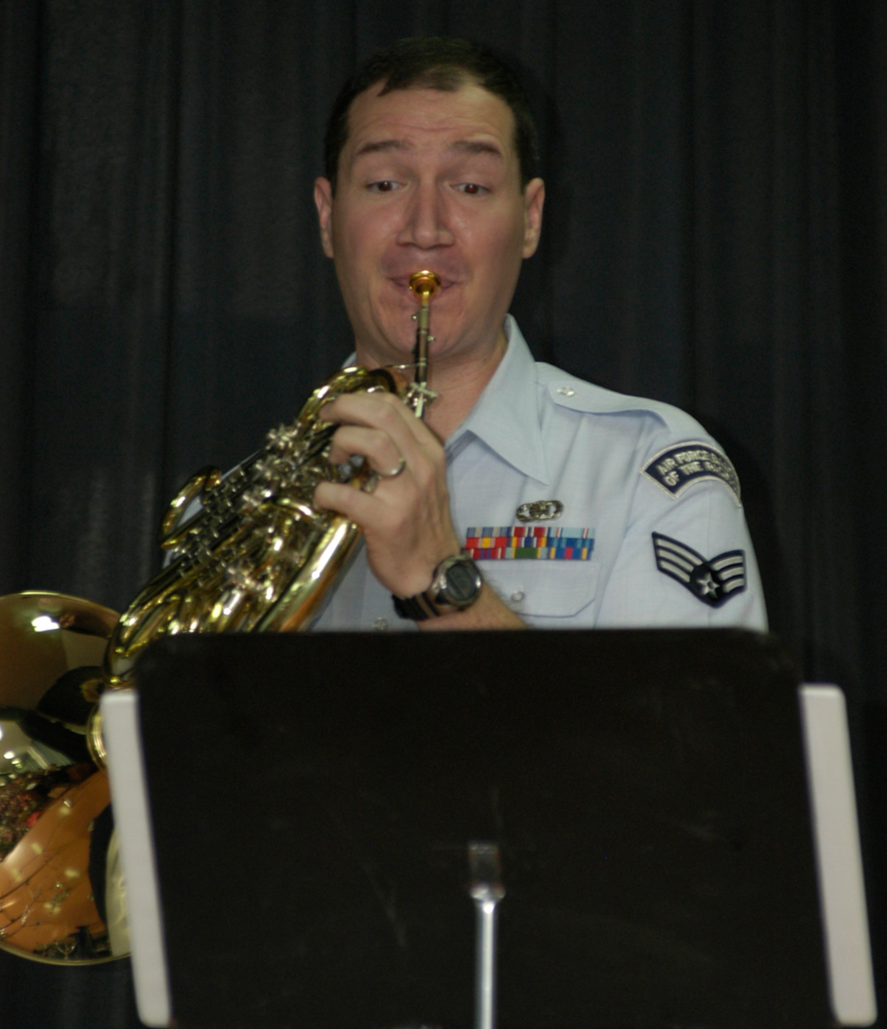 KUNSAN AIR BASE, South Korea -- Air Force Band of the Pacific french horn player Senior Airman Craig Matta performs for students at Na Po Elementary School during the groups performance at the local Gunsan City School Dec. 5. The Elmendorf Air Force Base, Alaska based band performed for more than 300 students, parents and teachers as part of their civic outreach and the base's Good Neighbor Program. (U.S. Air Force Photo/Master Sgt. Sean P. Houlihan)