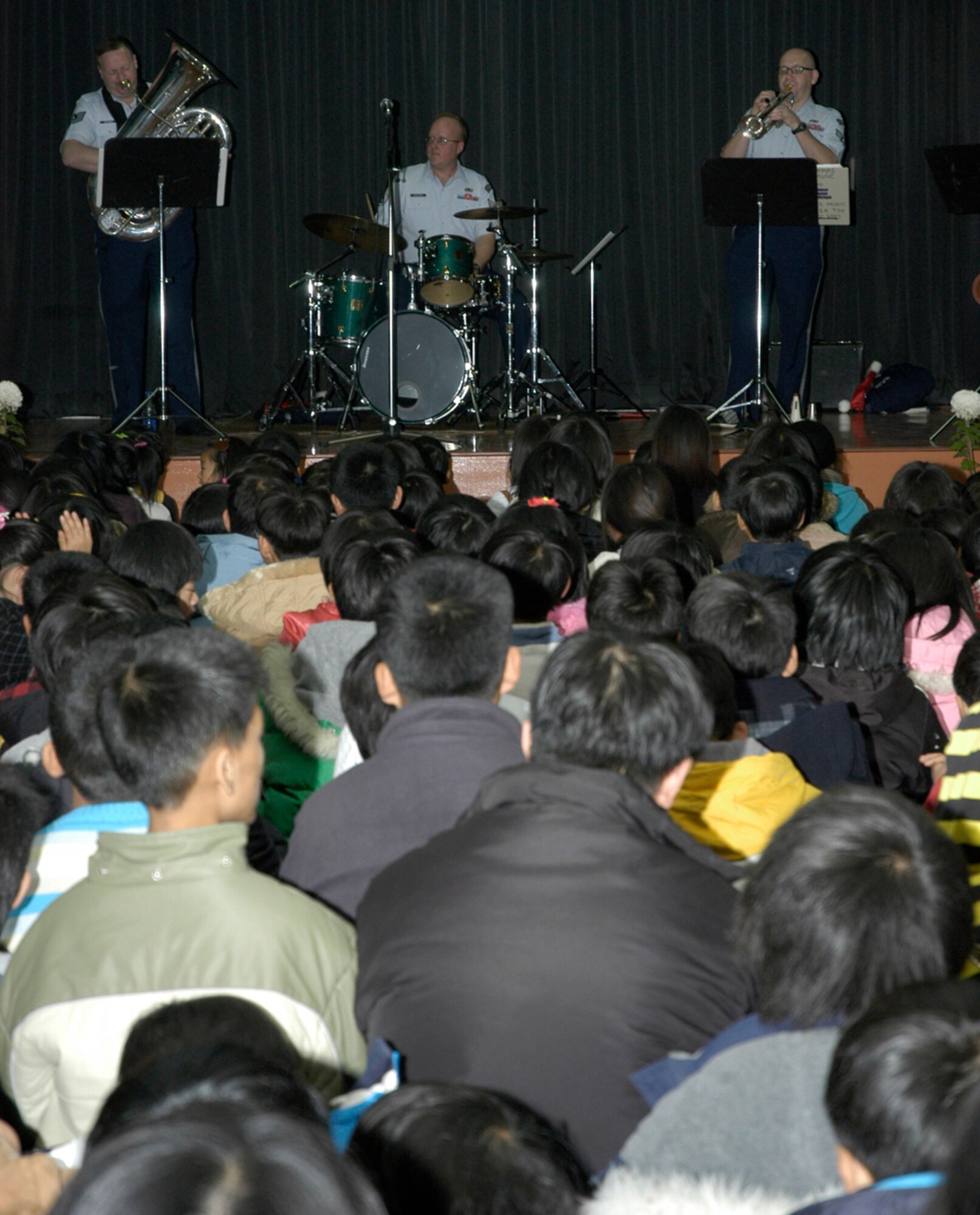 KUNSAN AIR BASE, South Korea -- Air Force Band of the Pacific performs for students at Na Po Elementary School during the groups performance at the local Gunsan City School Dec. 5. The Elmendorf Air Force Base, Alaska based band performed for more than 300 students, parents and teachers as part of their civic outreach and the base's Good Neighbor Program. (U.S. Air Force Photo/Master Sgt. Sean P. Houlihan)