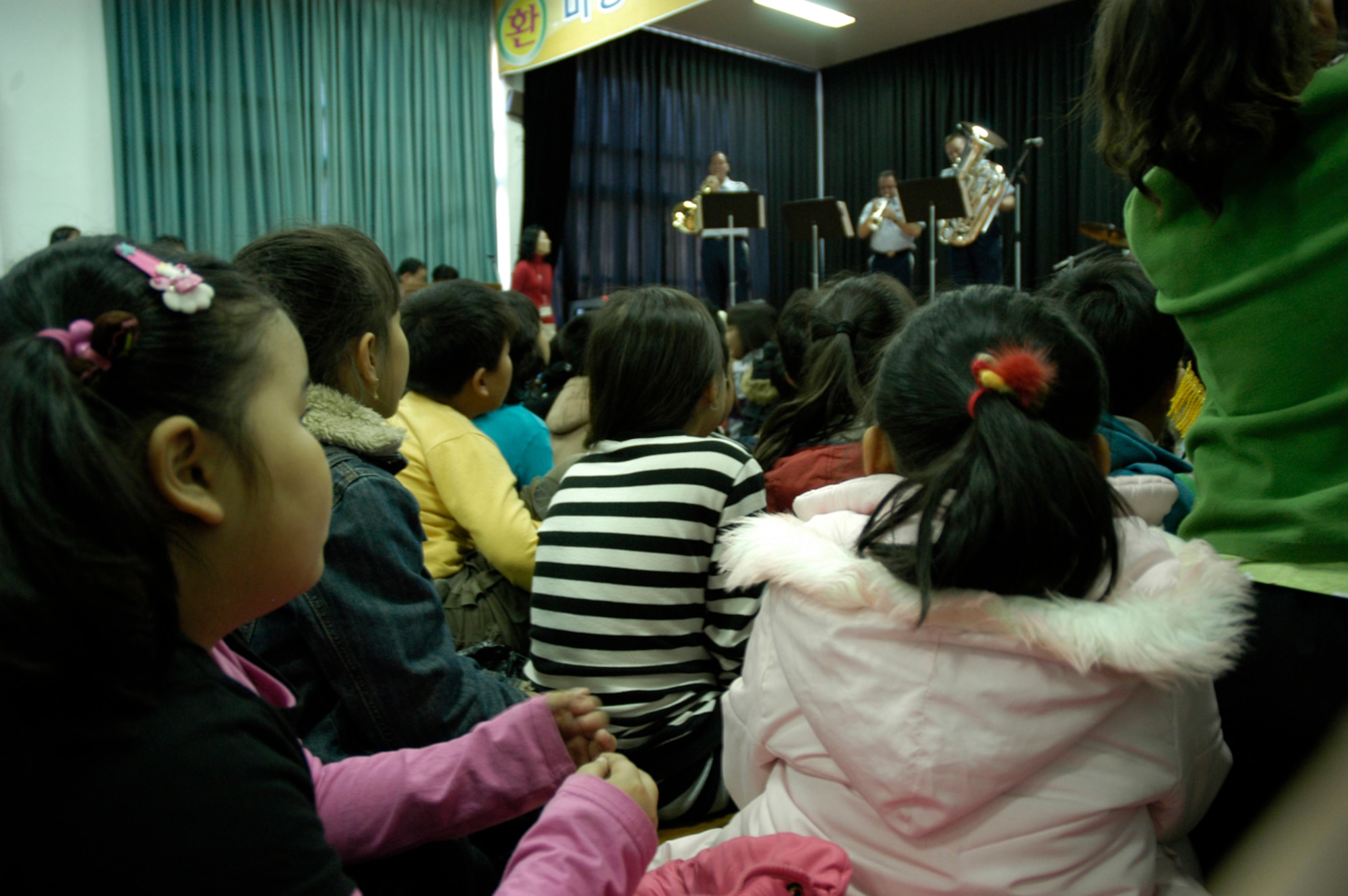 KUNSAN AIR BASE, South Korea -- Students of Na Po Elementary School enjoy the music of the Air Force Band of the Pacific during their performance at the local Gunsan City School Dec. 5. The Elmendorf Air Force Base, Alaska based band performed for more than 300 students, parents and teachers as part of their civic outreach and the base's Good Neighbor Program. (U.S. Air Force Photo/Master Sgt. Sean P. Houlihan)