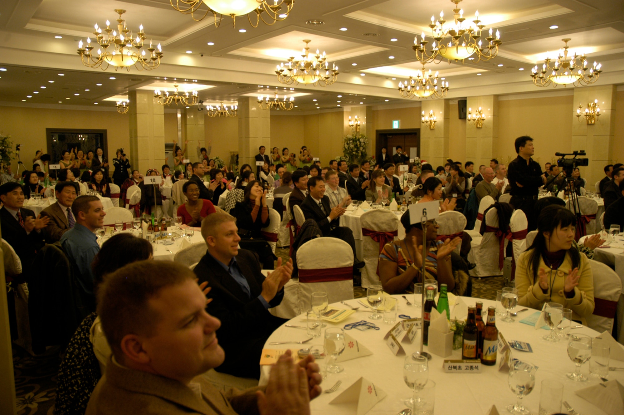 KUNSAN AIR BASE, South Korea -- Attendees at the Gunsan City Board of Education Friendship and Volunteer Appreciation dinner appluad for the Air Force Band of the Pacific after their performance Dec. 4. The Elmendorf Air Force Base, Alaska based band performed holiday music and jazz pieces at the event as part of their civic outreach and the base's Good Neighbor Program. (U.S. Air Force Photo/Master Sgt. Sean P. Houlihan)