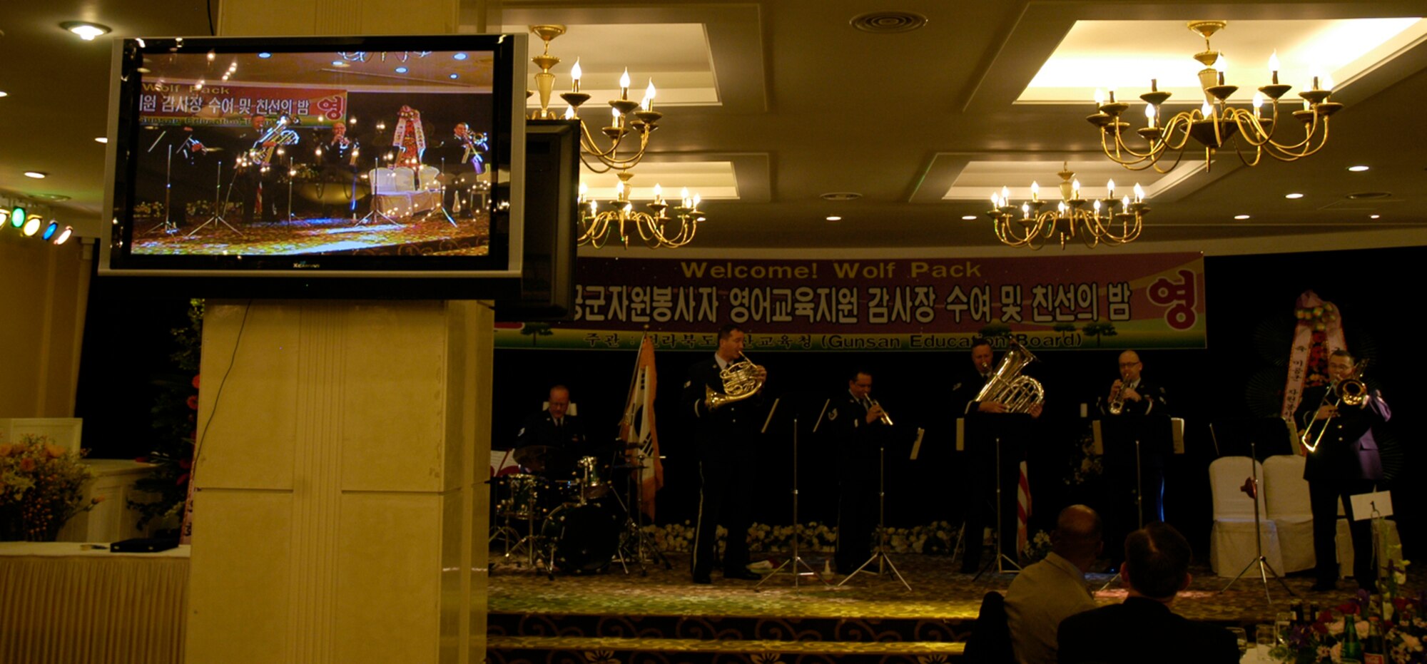 KUNSAN AIR BASE, South Korea -- The Air Force Band of the Pacific performs a Christmas carol at the Gunsan City Board of Education Friendship and Volunteer Appreciation dinner for 8th Fighter Wing Airmen, and students, parents and teachers from local Gunsan City elementary schools Dec. 4. The Elmendorf Air Force Base, Alaska based band performed holiday music and jazz pieces at the event as part of their civic outreach and the base's Good Neighbor Program. (U.S. Air Force Photo/Master Sgt. Sean P. Houlihan)