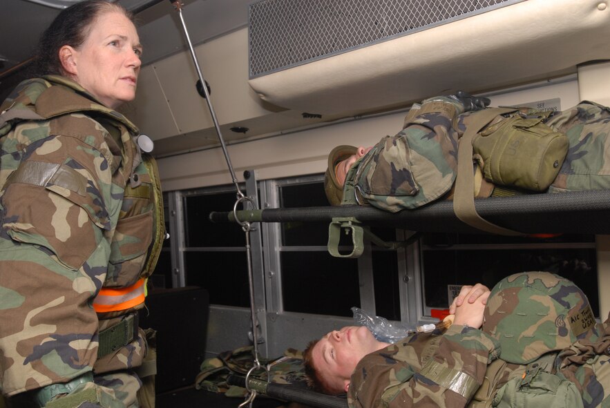 Capt. Barbara Smith, 18th Medical Operations Squadron, watches over victims of smoke inhalation being transported on a bus to Lester Naval Hospital, at Camp Lester, Japan. The simulated victims were from an attack scenario at Bldg. 46810 during Local Operational Readiness Exercise Beverly High 08-2 held at Kadena Air Base, Japan, Dec. 5, 2007. These scenarios enable base agencies to work together, mitigate real-world situations, and heighten readiness capabilities.
(U.S. Air Force photo/Staff Sgt. Chrissy FitzGerald)