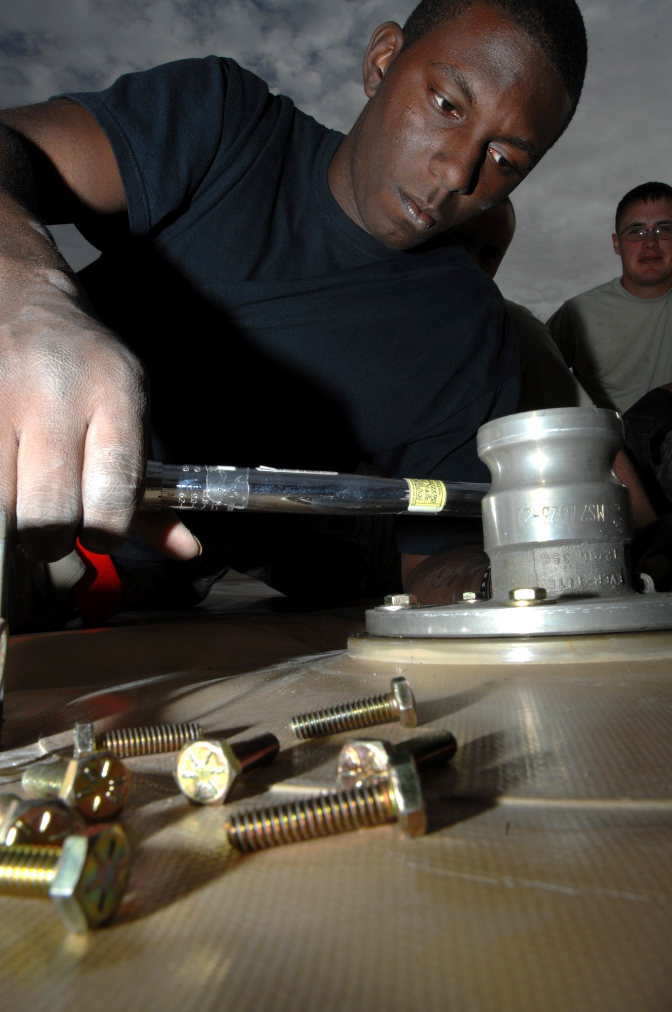 Senior Airman Dafinus Harris torques the bolts on a connection port on a new fuel bladder Dec. 3 at Ali Base, Iraq.  Airmen from the 407th Expeditionary Logistics Readiness Squadron fuels shop periodically replace fuel bladders to prevent ruptures.  The new bladder can hold up to 50,000 gallons of fuel.  Airman Harris is deployed from Kadena Air Base, Japan. (U.S. Air Force photo/Airman 1st Class Jonathan Snyder)