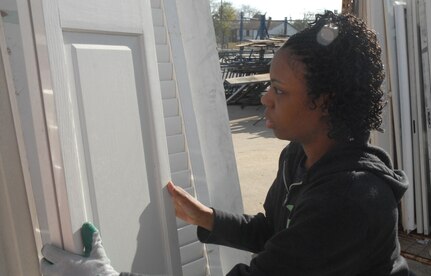 Senior Airman Melissa Jackson, 437th Logistics Readiness Squadron, places a door in the serviceable door pile Saturday after being inspected at the Habitat for Humanity outdoor storage are in downtown Charleston (U.S. Air Force photo/Tech. Sgt. Paul Kilgallon)   