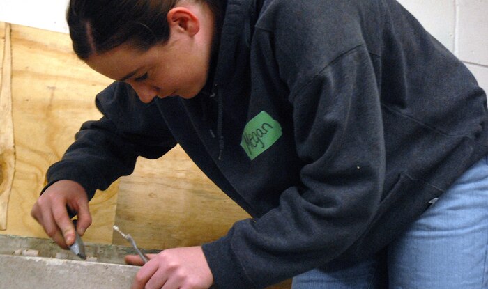 Airman 1st Class Megan Latteyer, 437th Logistics Readiness Squadron, removes a hinge from a donated door Saturday at the Habitat for Humanity donation center in downtown Charleston. (U.S. Air Force photo/Tech. Sgt. Paul Kilgallon)