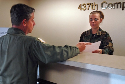 Airman Brittney Knowling, 437th Comptroller Squadron financial management specialist, helps Senior Master Sgt. Ken Bradley, 315th Airlift Wing Airlift Control Flight loadmaster, with a supplemental travel voucher Wednesday on base. (U.S. Air Force photo/Airman Melissa White)