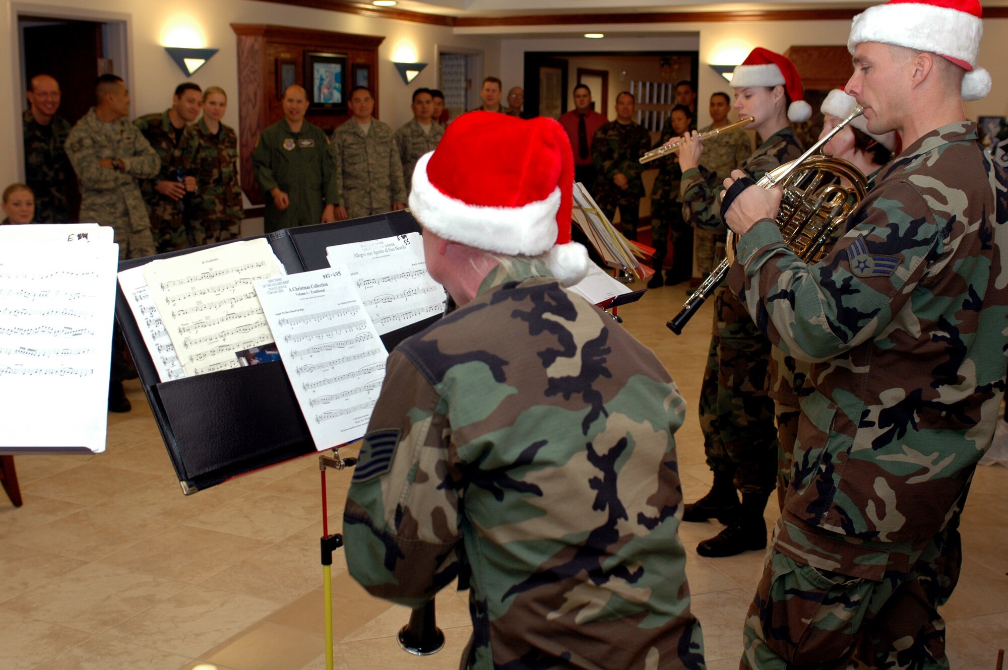 Members of the U.S. Air Force Band of the Golden West perform Christmas music to members of the 60th Air Mobility Wing in Bldg. 51 Dec. 5. The quintet traveled around the base providing entertainment to Team Travis. (U.S. Air Force photo/Senior Airman Shaun Emery)