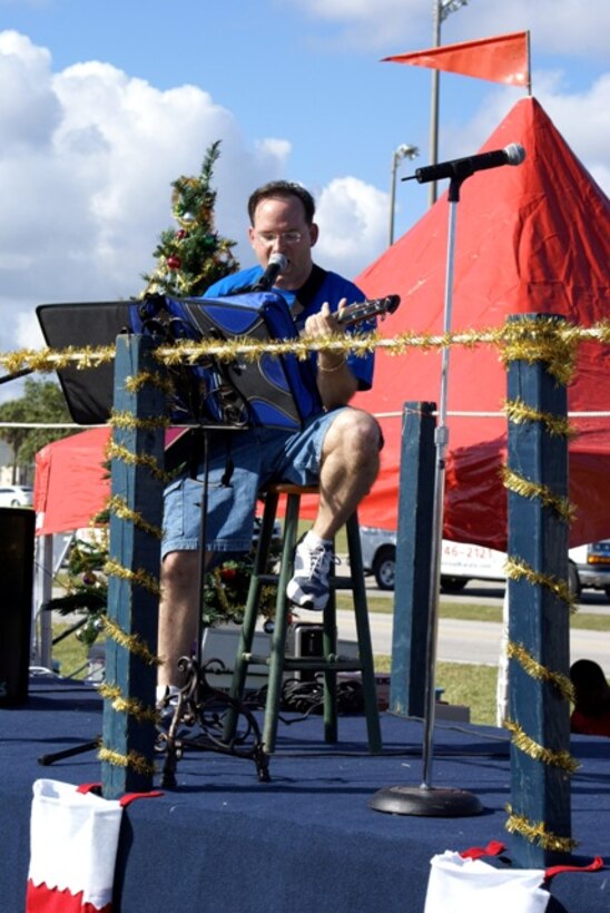 Tech. Sgt. Robert Clark, 482nd Fighter Wing historian, entertained with crowd-favorites and some of his original songs. The 482nd Fighter Wing hosted a Family Day for about 1,400 wing reservists who regularly take time away from their civilian careers and families to serve part or full-time in the Air Force Reserve. The celebration served as a way to thank families for their support and foster unit camaraderie. Picnic attractions included softball games, bingo, live entertainment, a bounce house and inflatable slides for children, an appearance by Santa and free raffles. (U.S. Air Force Photo/Senior Airman Erik Hofmeyer)
