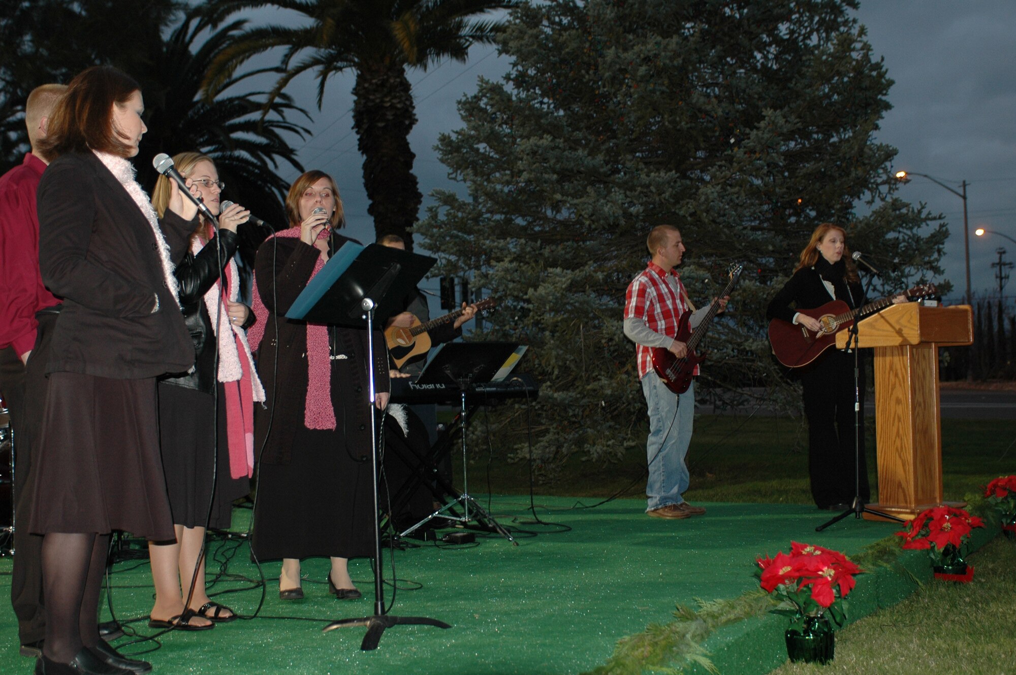 The 60th Air Mobility Wing Chapel Contemporary Band performs for members of Team Travis during this year’s Christmas tree and Menorah lighting ceremony Dec. 3. Members of Team Travis sang carols and enjoyed refreshments prior to the lighting of the tree. (U.S. Air Force photo/Senior Airman Shaun Emery)