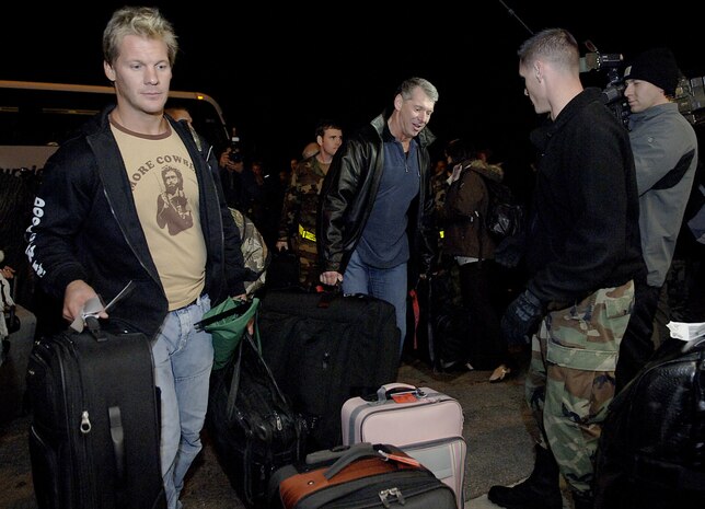 Chris Jericho, left, and Vince McMahon, right, both performers with the World Wrestling Entertainment, Inc., hand their bags off to Airmen from the 437th Aerial Port Squadron to be palletized for their flight on a Charleston C-17 to Ramstein Air Base, Germany, and on to Iraq for WWE's annual "Tribute to the Troops." This is the fifth year World Wrestling Entertainment, Inc., and Armed Forces Entertainment have teamed together to bring entertainers overseas to visit military servicemembers at forward deployed locations. (U.S. Air Force photo/Senior Airman Nicholas Pilch)