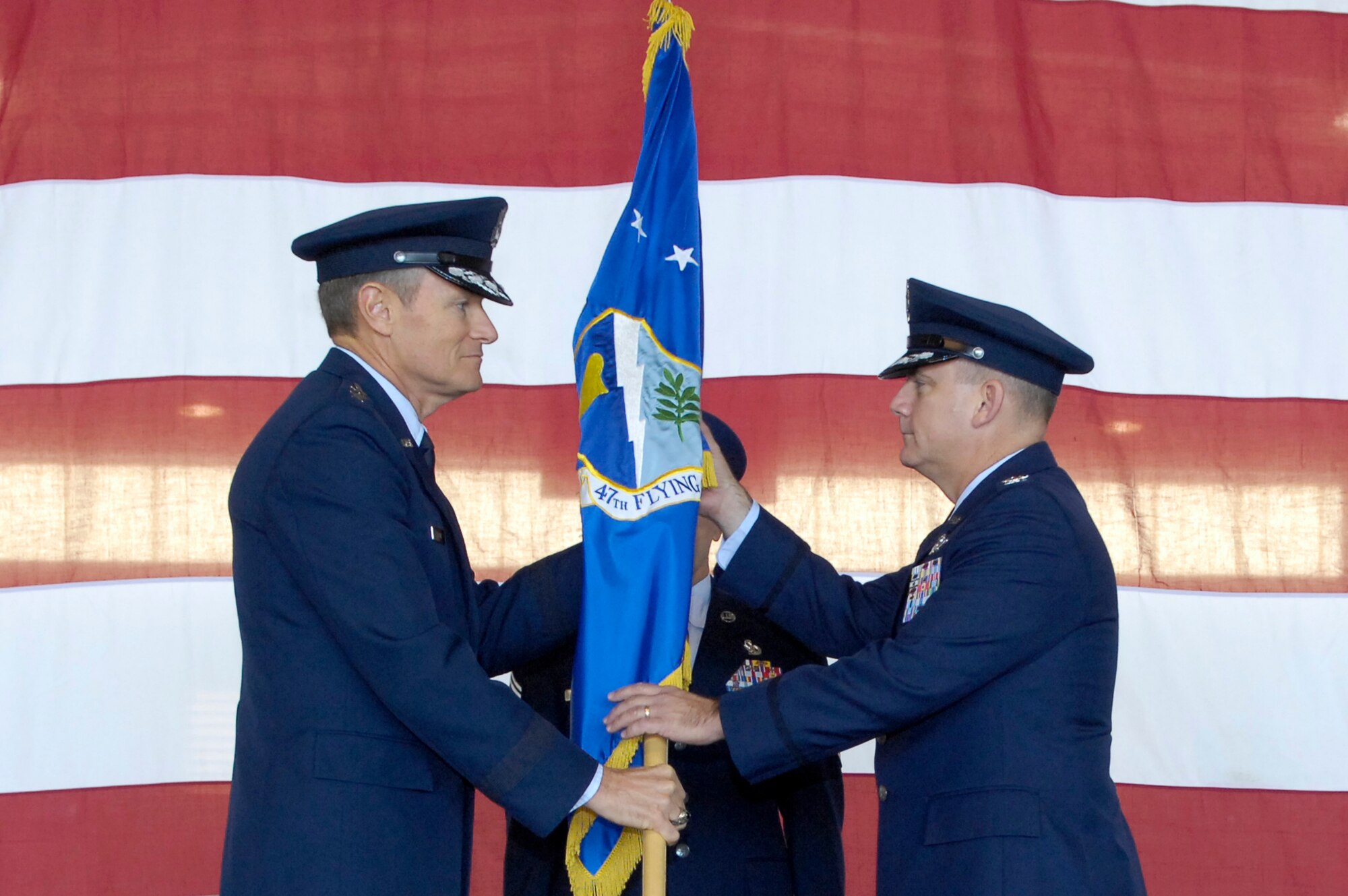 Maj. Gen. Irving L. Halter, 19th Air Force commander, passes the guidon of the 47th Flying Training Wing to Col. John W. Doucette during a change-of-command ceremony here Dec. 4. (U.S. Air Force photo/ Jose Mendoza)