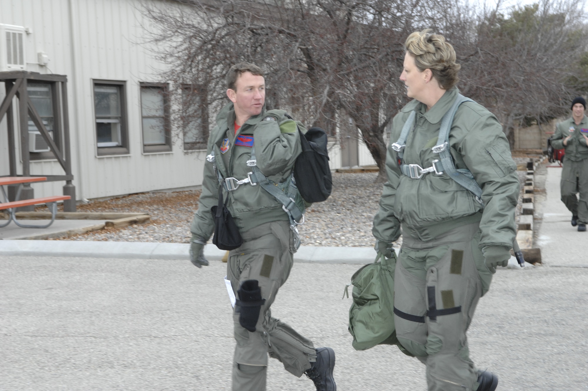 MOUNTAIN HOME AIR FORCE BASE, Idaho -- Paula Riggs from Washington Mutual Bank in Mountain Home walks towards the flightline with Maj. Christopher Ederle, F-15E pilot, here Nov. 30. Riggs received an incentive flight along with two other lucky Honorary Commanders. (U.S. Air Force photo/ Airman 1st Class Dana Hill)