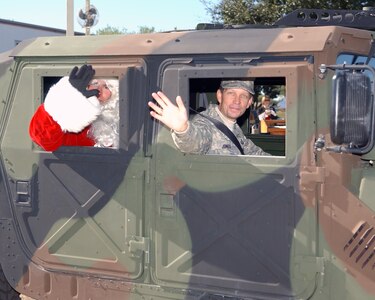 Exchanging his sleigh for a military vehicle, Brig. Gen. Darrell Jones and Santa lead a Yellow Checker Cab parade after being part of a state-wide campaign to remind people to not drink and drive on Dec. 4, 2007. The Texas Department of Transportation used Lackland Air Force Base, Texas, as a backdrop to announce the beginning of its annual four-week drunken driving prevention campaign. This is the 10th year of the Texas Department of Transportation's holiday public education campaign. General Jones is the former commander of the 37th Training Wing.  (USAF photo by Alan Boedeker)                               