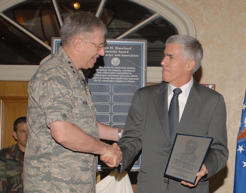 Lt. Gen. Roger Brady, Air Force deputy chief of staff for personnel, presents the first Roger M. Blanchard Memorial Award for Character and Innovation to John Beckett at the 2007 Worldwide Manpower and Personnel Training and Professional Development Conference in San Antonio Nov. 30.   Mr. Beckett serves as the Air Force’s Survivor Assistance Program manager at the Pentagon.  The new award honors the former assistant deputy chief of staff for Manpower and Personnel who passed away Sept. 30, 2007. (Photo by Javier Garcia)