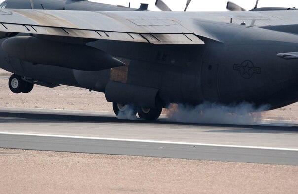 A C-130 Hercules touches down with smoking wheels on the landing strip of a Southwest Asia air base on September 29, 2007. The C-130 has been the workhorse of the U.S. Air Force since December 1956 when the C-130A model was brought into service for the Air Force. (USAF photo by Staff Sgt. Douglas Olsen)