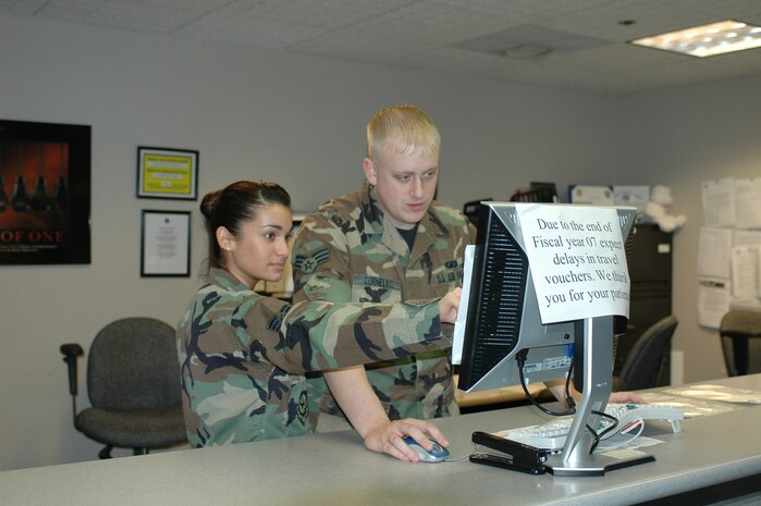 Senior Airmen Laurina Sousa and Senior Airman Kenneth Cornelius work together in the 60th Comptroller Squadron’s customer service lobby. The squadron’s customer service section is its face, fielding questions and concerns from servicemembers and helping to solve problems. (U.S Air Force photo/Nick DeCicco)