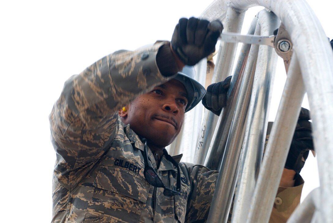Staff Sgt. Andy Gilbert tightens a support beam to the frame of a temporary shelter Dec. 5 at Balad Air Base, Iraq. The new shelter will house vehicles for the 332nd Expeditionary Civil Engineer Squadron Explosive Ordnance Disposal Flight. Sergeant Gilbert, a 332nd ECES structural technician, is deployed from Yokota Air Base, Japan. (U.S. Air Force photo/Staff Sgt. Joshua Garcia) 
