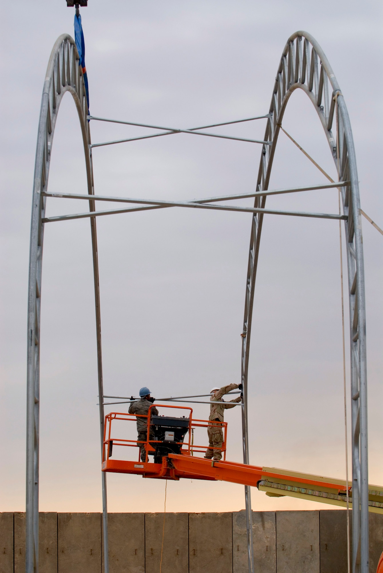 Members of the 332nd Expeditionary Civil Engineer Squadron erect the frame of a temporary shelter Dec. 5 at Balad Air Base, Iraq. The shelter will be used by the 332nd ECES Explosive Ordnance Disposal Flight. (U.S. Air Force photo/Staff Sgt. Joshua Garcia) 
