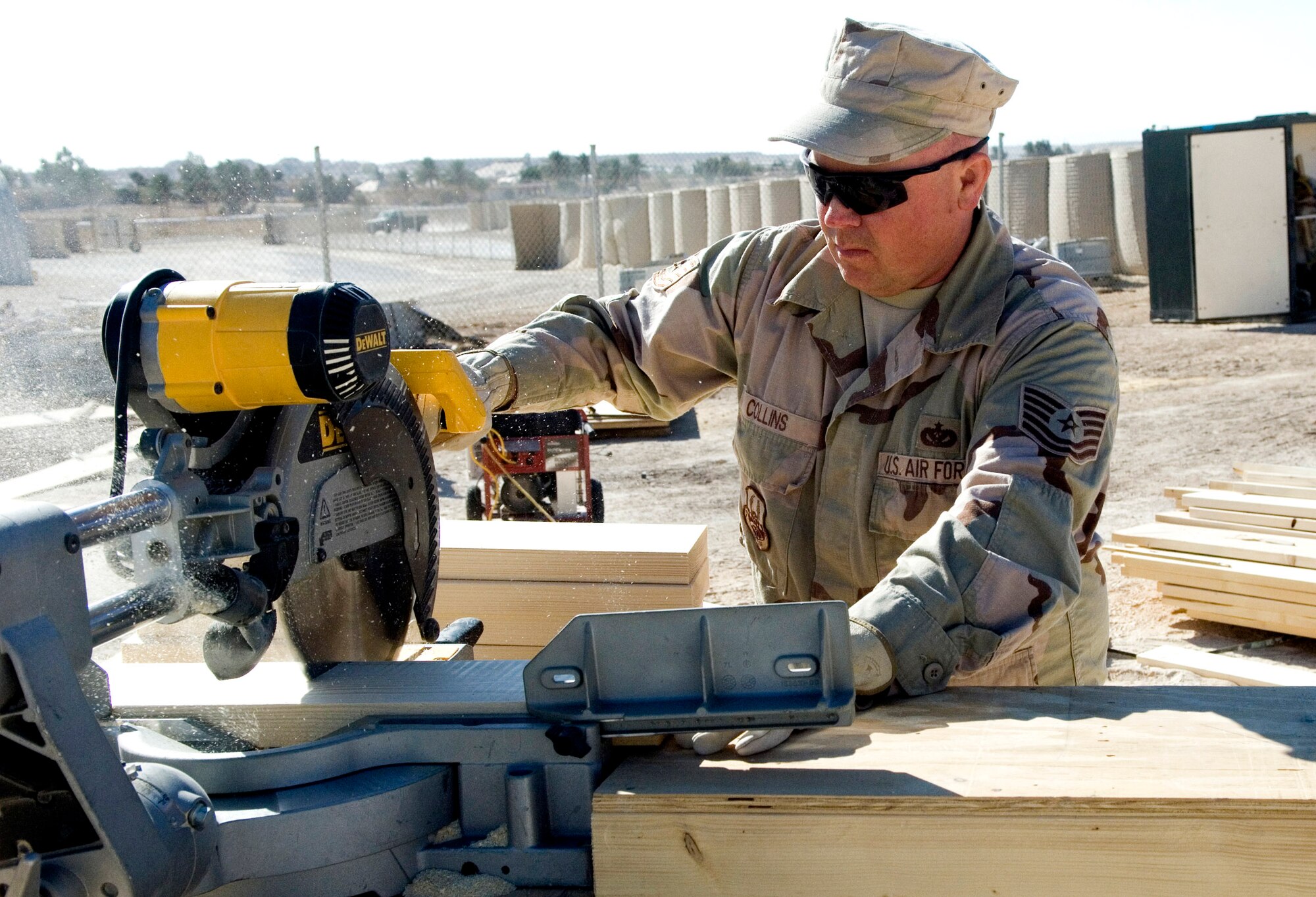 Tech. Sgt. Chris Collins cuts a 2-by-6 piece of wood to use as a frame for a bench Nov. 24 at Al Asad Air Base, Iraq. REDHORSE Airmen are currently working approximately $9.8 million in projects here. Sergeant Collins, a 557th Expeditionary REDHORSE utilities technician, is deployed from Minot Air Force Base, N.D. (U.S. Air Force photo/Staff Sgt. Travis Edwards) 
