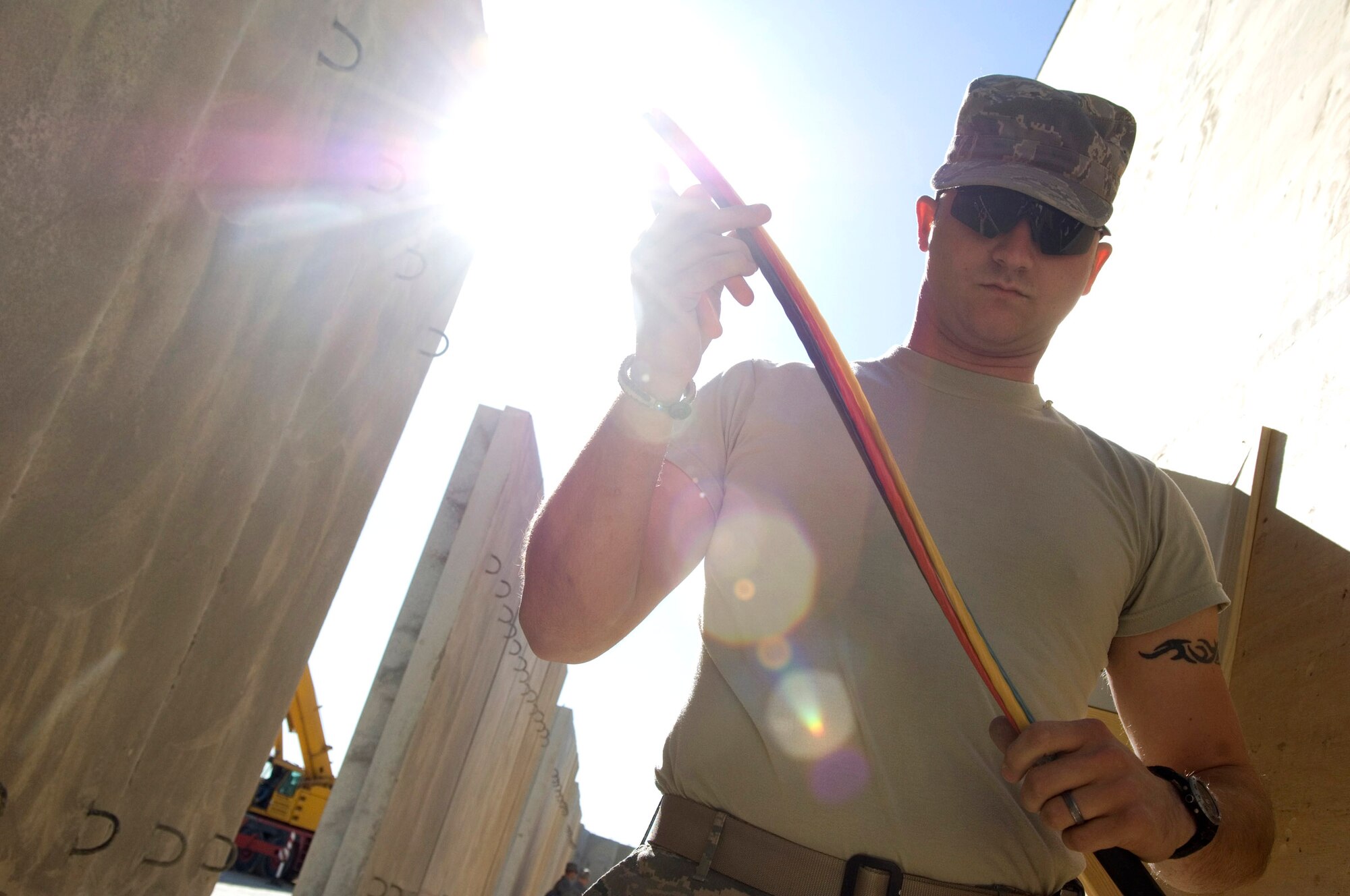 Senior Airman Jimmy White strips cable for the newly-constructed convoy briefing rooms here, a $65,000 project, Nov. 22 at Al Asad Air Base, Iraq. Airman White, a 557th Expeditionary REDHORSE electrician, is deployed from Barksdale Air Force Base, La. (U.S. Air Force photo/Staff Sgt. Travis Edwards)