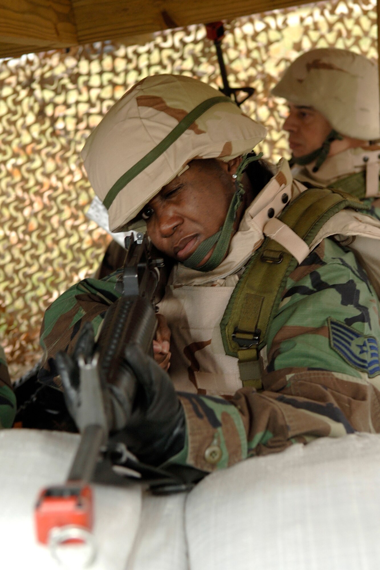 HANSCOM AFB, Mass. -- Tech. Sgt. Jillian John, 66th Mission Support Squadron, takes aim during a defensive fighting positions training session Nov. 29 at Camp Patriot.  Camp Patriot was the hands-on training and practical applications site for Expeditionary Airman Combat Skills Training.  (U.S. Air Force photo by Jan Abate)