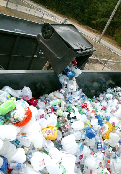 Dana Green dumps a load of plastic bottles into a recycle bin Nov. 27 at Shaw Air Force Base, S.C. Base officials recycle aluminum cans, plastic and glass bottles, office paper, newspaper, magazines, cardboard, printer cartridges, shoes and metals. Mr. Green is a Shaw AFB recycle center attendant. (U.S. Air Force photo/Staff Sgt. John Gordinier)