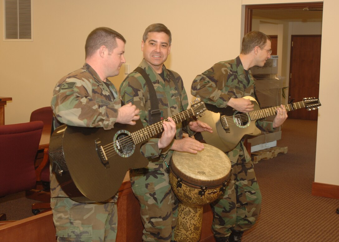 The Air Force band, Night Wing, members Staff Sgt. Dan Bragden, Master Sgt. Doug Montera and Staff Sgt. Clint Whitney play the all time great song "Freebird" by Lynard Skynard while performing at Grand Forks Air Force Base Nov. 27. The band is part of the Heartland of America Band and is part of Air Combat Command stationed at Offutt Air Force Base, Neb. (U.S. Air Force photo/Senior Airman Chad M. Kellum)