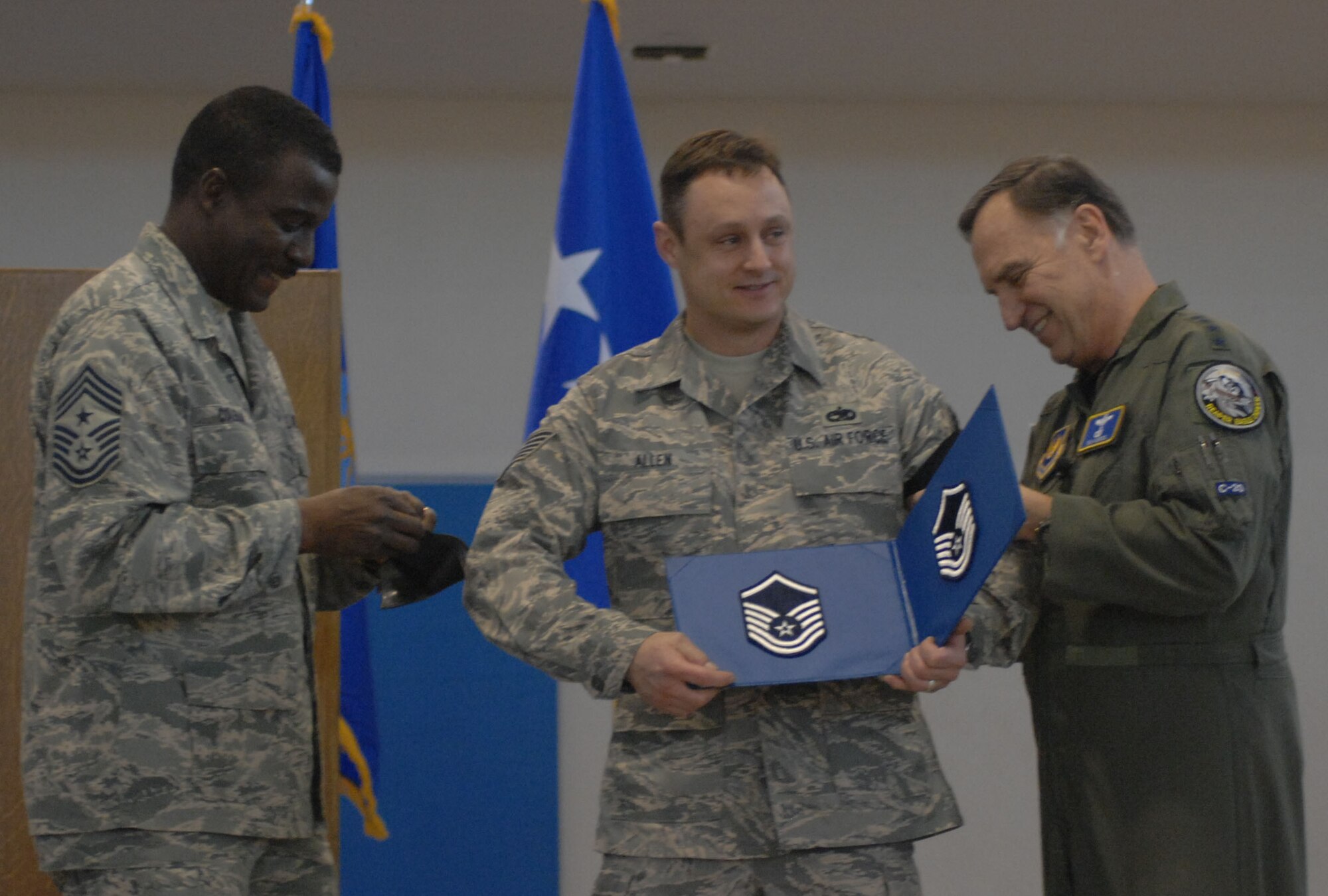 Gen. William T. Hobbins, U.S. Air Forces in Europe commander, STEP-promotes Tech. Sgt. Christopher Allen, 100th Communications Squadron, after giving his last speech at RAF Mildenhall Dec. 3, 2007. (U.S Air Force photo by Airman 1st Class Brad Smith)