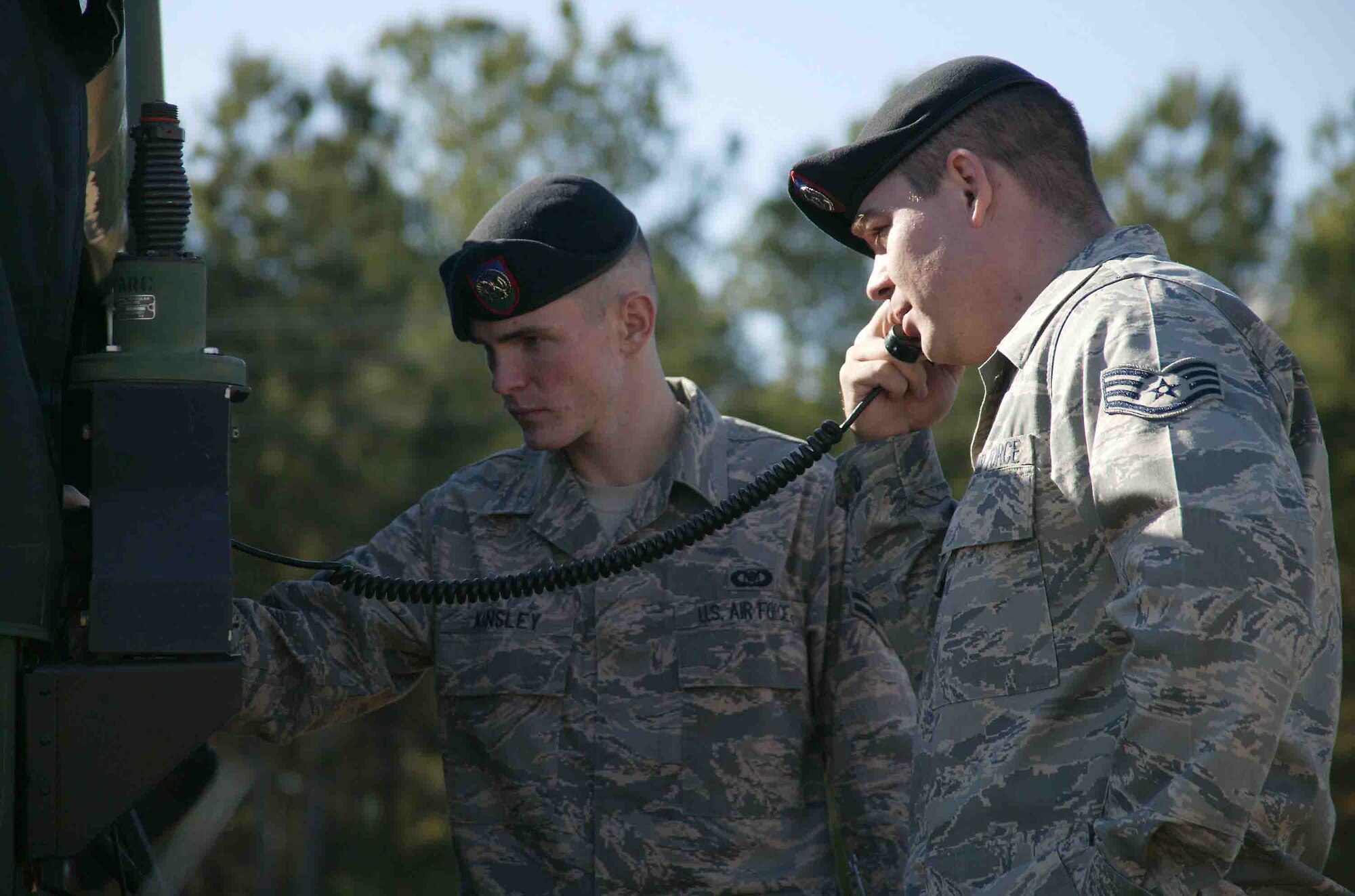 SHAW AIR FORCE BASE, S.C. -- Staff Sgt. Ryan Fausey, 682nd Air Support Operations Squadron tactical air control party controller, performs a radio check over satellite communications on the Joint Air Request Net while Airman 1st Class John Kinsley, 682nd ASOS TACP controller, makes an adjustment Dec. 4. Sergeant Fausey is Air Combat Command's Annual Winner of the Fighter Duty Technician Award for 2007. The FDT award recognizes outstanding individual performance by TACP specialists in execution of joint terminal attack controller, TACP apprentice, and fighter duty technician duties. (U.S. Air Force photo/Staff Sgt. John Gordinier)