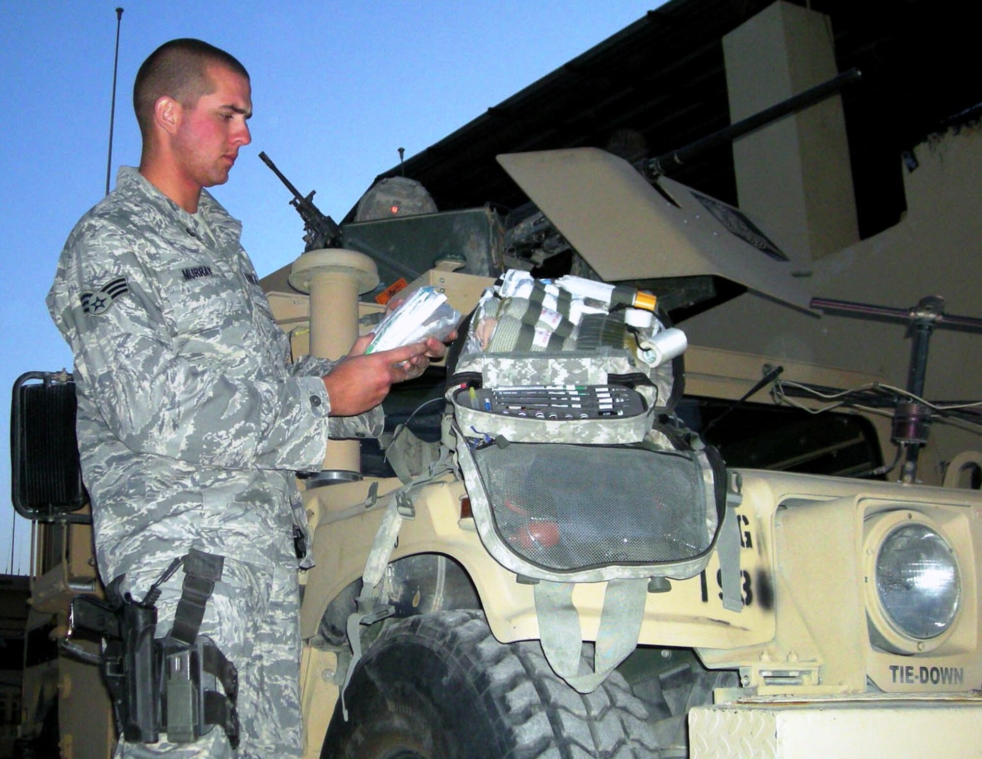 FORWARD OPERATING BASE MAHOLIC, Afghanistan -- Senior Airman Neil Murray, a combat medic here, stocks his medical bag before heading out on a convoy. Combat medics are usually the first to treat wounded servicemembers and stabilize them for transport to medical facilities. (DoD Photo by Spc. Daniel Richardson)