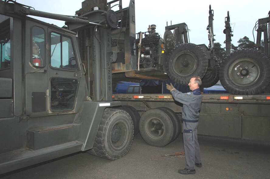 Hubertus Coburg, 86th Construction and Training Squadron, guides the forklift to safely unload the mobile aircraft arresting system. (Photo by Airman 1st Class Amber Bressler)
