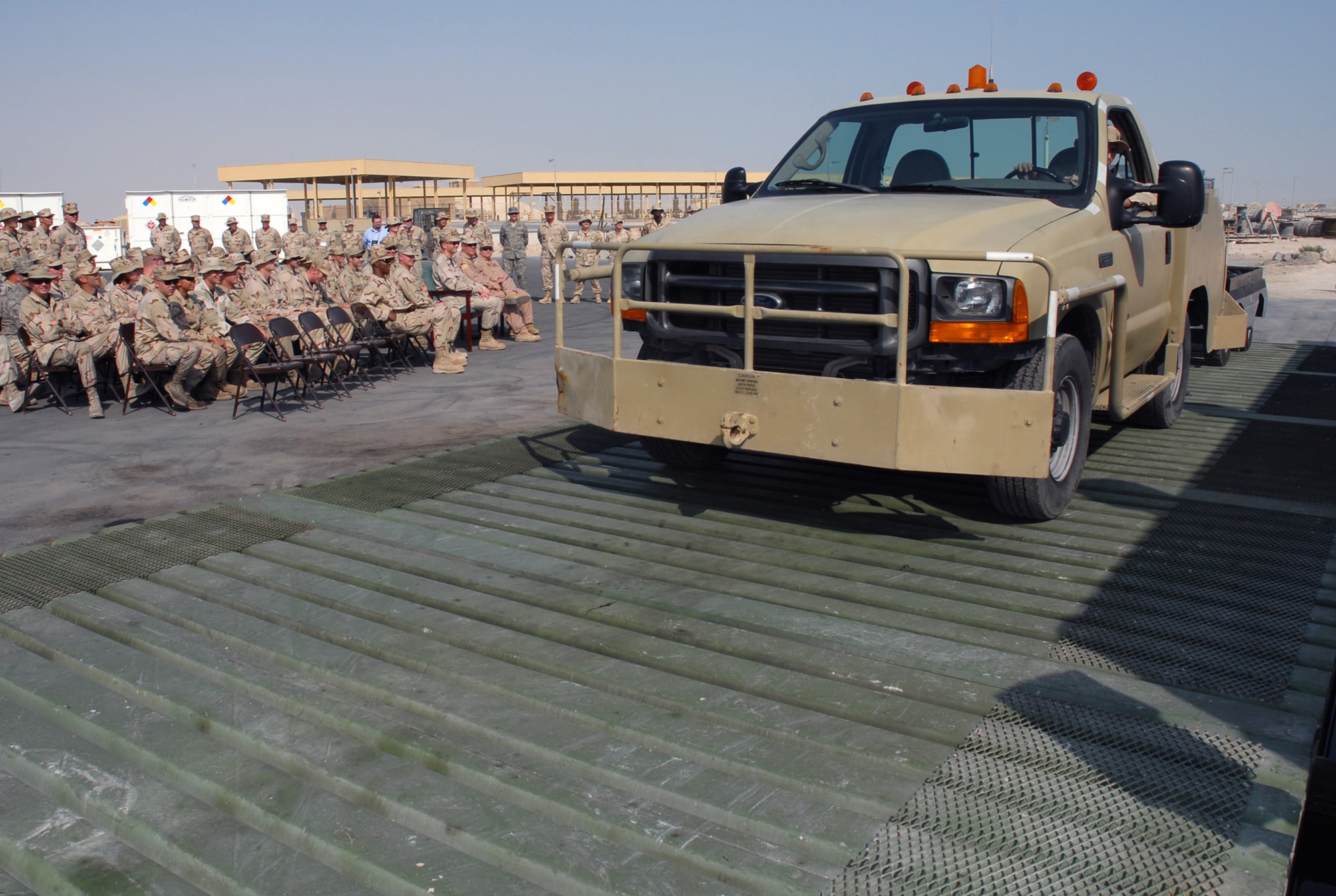 SOUTHWEST ASIA - The first vehicle rolls on to a newly installed vehicle wash rack at a Southwest Asia air base Dec. 3. The functional wash rack marks a milestone in the Air Ground Equipment shop's development project at the desert base. (U. S. Air Force photo/Staff Sgt. Douglas Olsen)