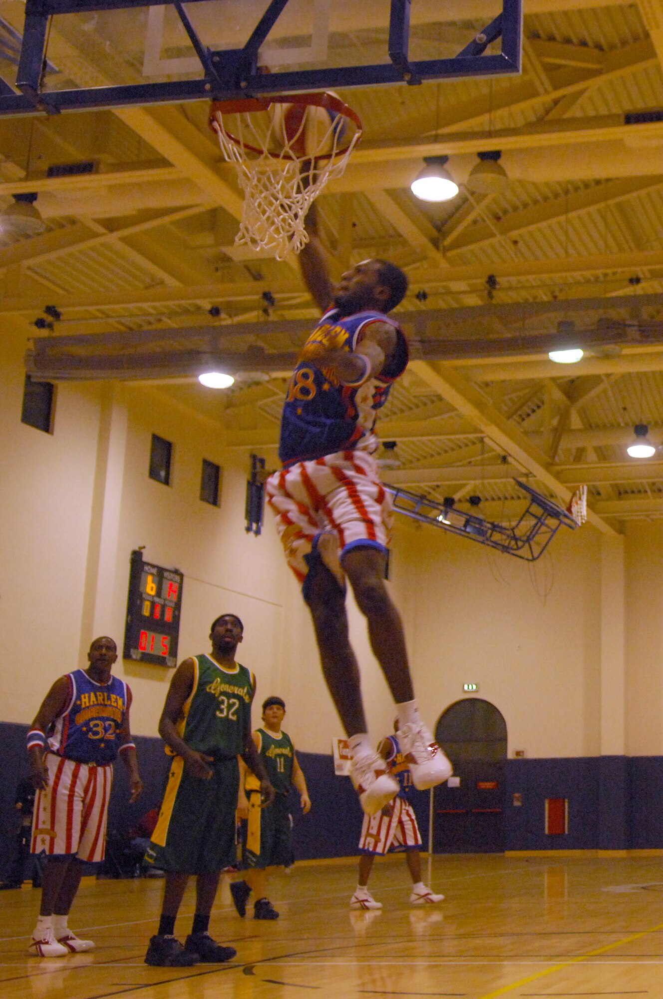 AVIANO AIR BASE, Italy-- A member of the Harlem Globetrotters throws down a monster dunk during the game at the Dragon Fitness Center on Aviano Air Base, Italy.  Dec. 1, 2007.  The Harlem Globetrotters are touring U.S. Army and Air Force  installations throughout Europe as part of their "Magic As Ever" 2008 world tour  (U.S. Air Force photo/Staff Sgt. Michael R. Holzworth) 