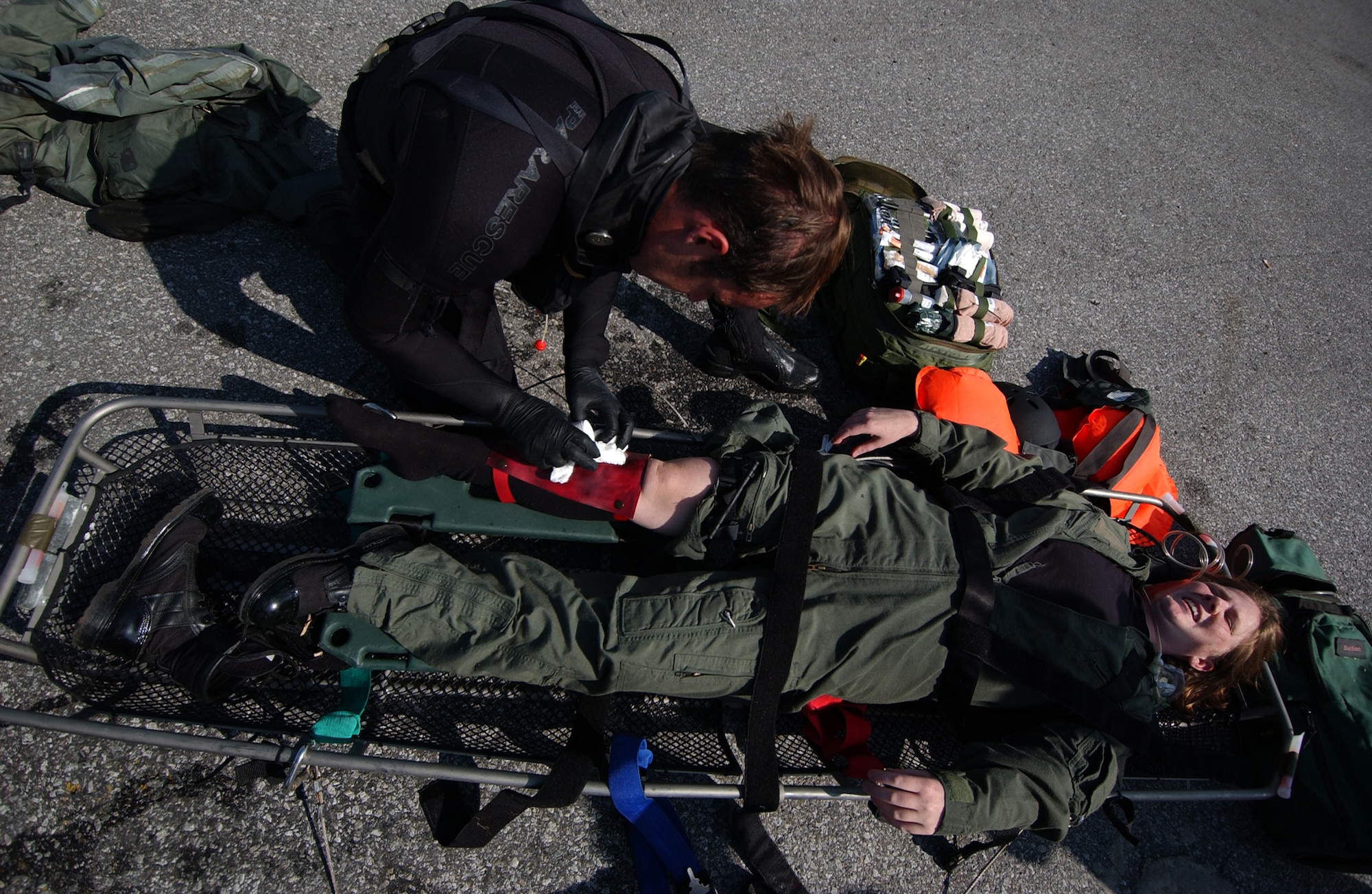 A pararescueman from the 31st Rescue Squadron treats an injured victim as part of a simulated water rescue during Local Operational Readiness Exercise Beverly High 08-02 at Kadena Air Base, Japan, Dec. 5, 2007. These scenarios enable pararescuemen to enhance their proficiency in water-based rescues and life-saving skills.
(U.S. Air Force photo/Tech. Sgt. Reynaldo Ramon)

